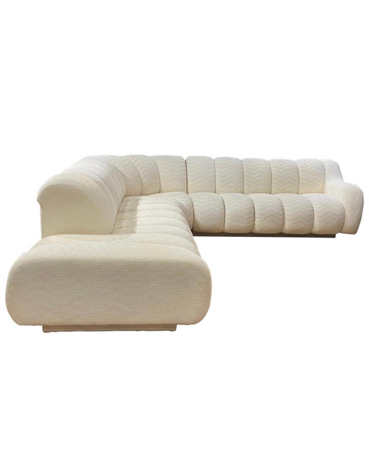 Iconic design. All original off white modern sectional made by Directional (Signed) Very much in the style that Steve Chase upholstered pieces are know for. Obtails original beautiful herringbone fabric in modern off white. Chaise built in on left