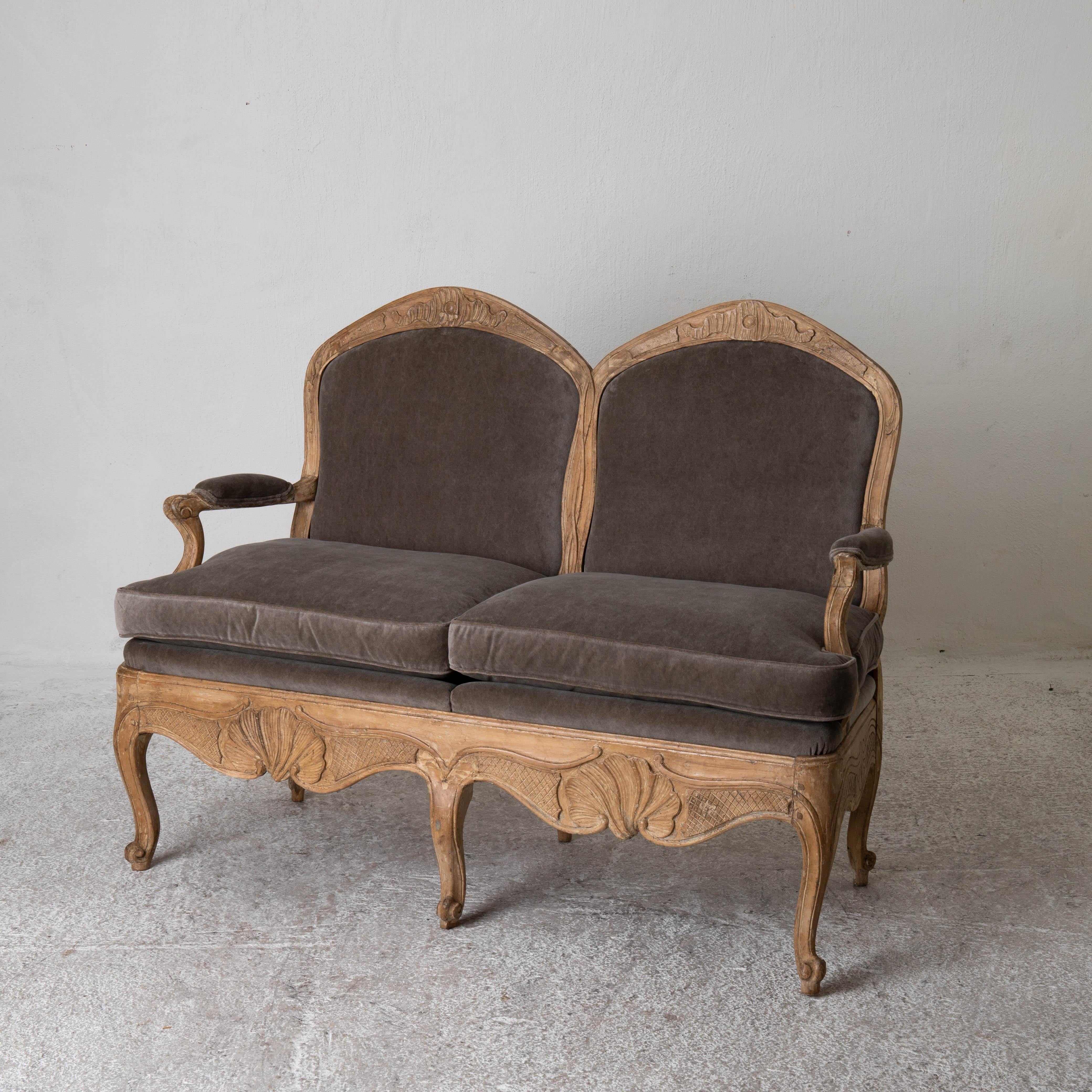 Sofa Settee Swedish Rococo Period Raw Finish Sweden. An all original sofa made during the Rococo period 1750-1775 in Sweden. Frame in a raw wood finish decorated with carvings typical for the rococo period. Upholstered in a taupe colored cotton