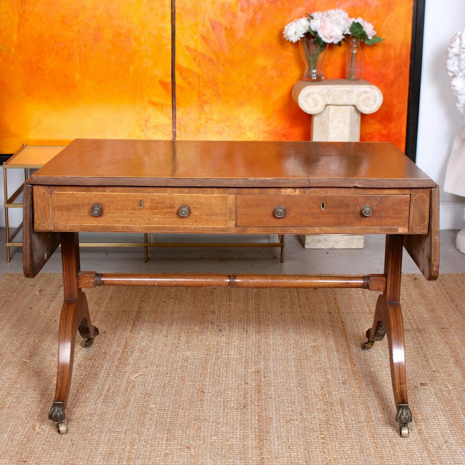 An impressive large 19th century mahogany sofa table.
The crossbanded top with rounded drop-ends above a frieze with single long drawers to each side beside dummy drawers. Raised on standards joined by a turned stretcher, with boxwood & ebony