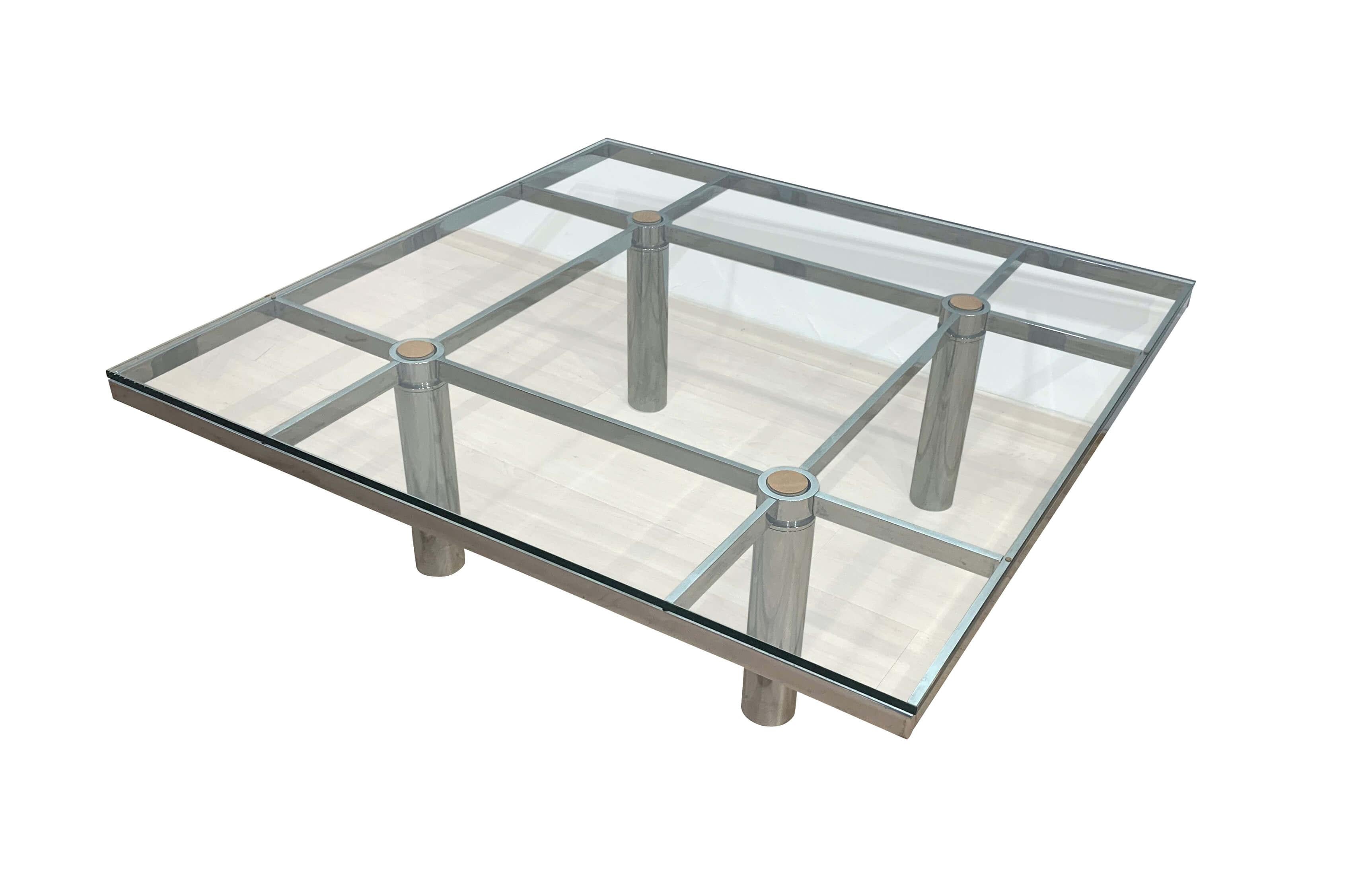 Italian sofa or coffee table „Andre“ by Afra & Tobia Scarpa for Gavina, circa 1970

Heavy chrome-plated flat steel frame, polished. Original thick clear glassplate (0.5“).
There are 4 bigger brown leather pads (removable) at the crossings as well as