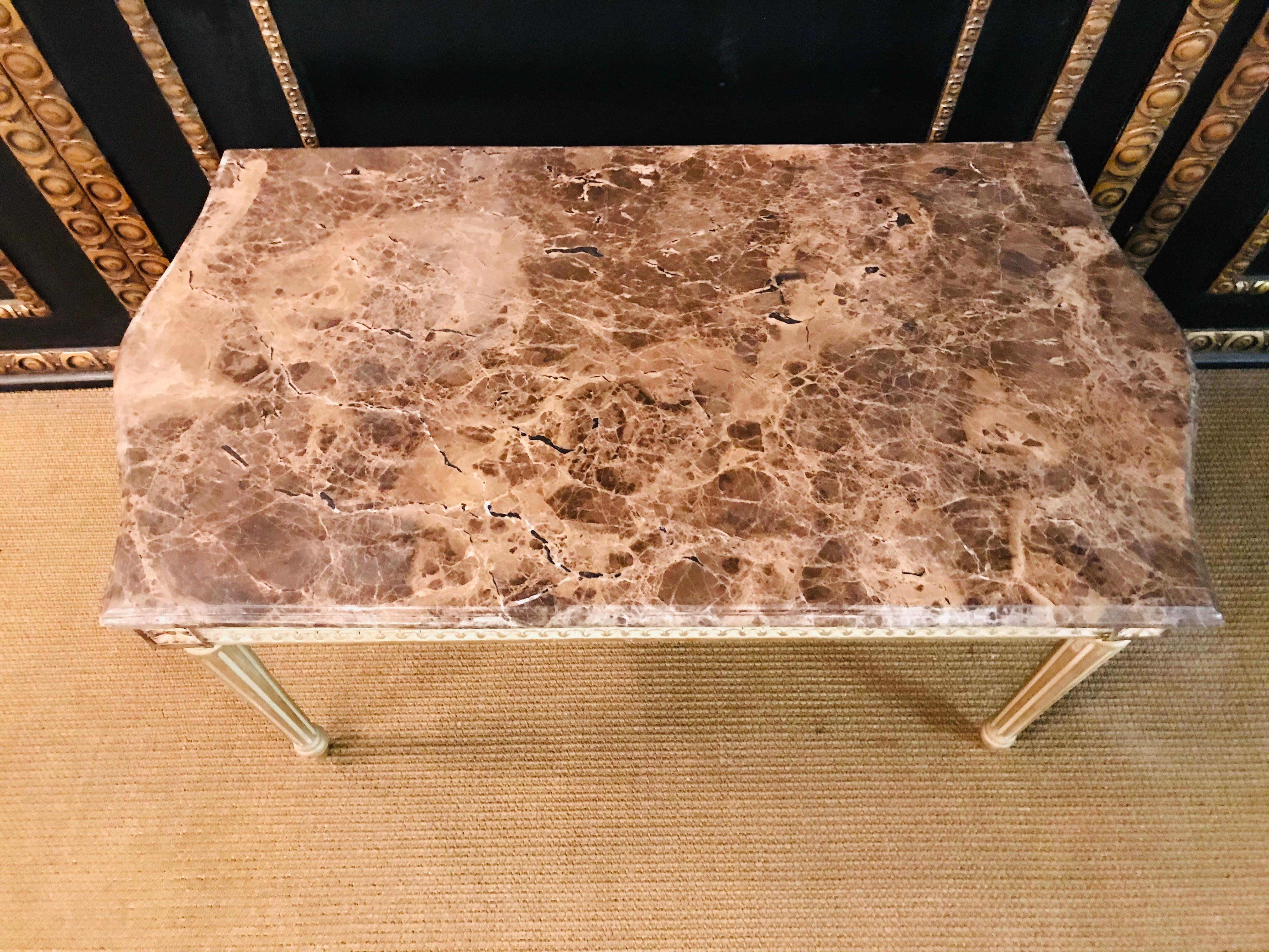 Solid beech carved on high legs. Frame with ribbon, rosettes and palmettes applied. Slightly protruding marble top. Gold-plated table in Louis Seize style. High-quality.
 