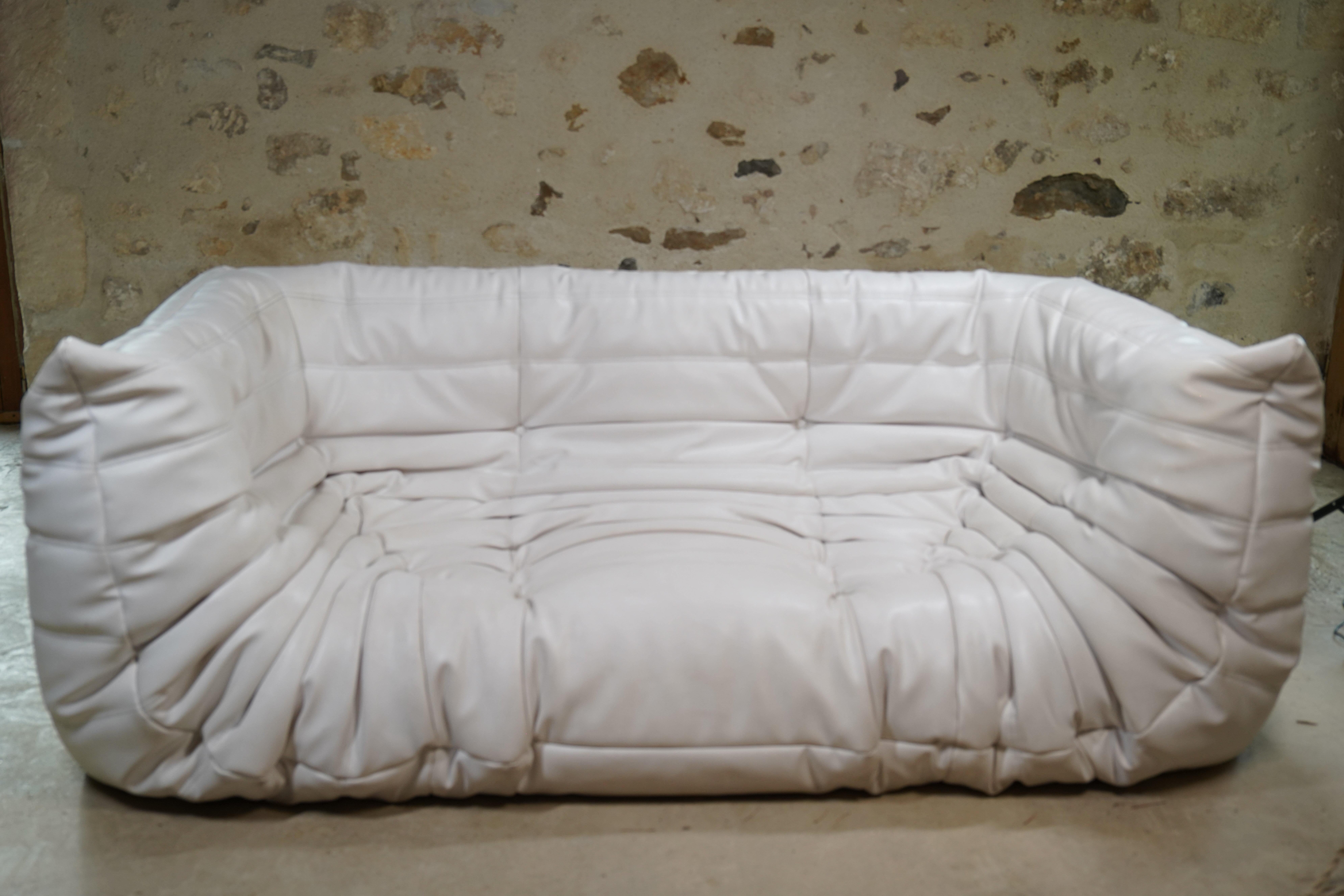 Gorgeous three-seater white leather Togo sofa designed by Michel Ducaroy for Ligne Roset from 2007. (2 available - another in separate listing).

Designer Michel Ducaroy drew inspiration for the Togo's design from an aluminum toothpaste tube