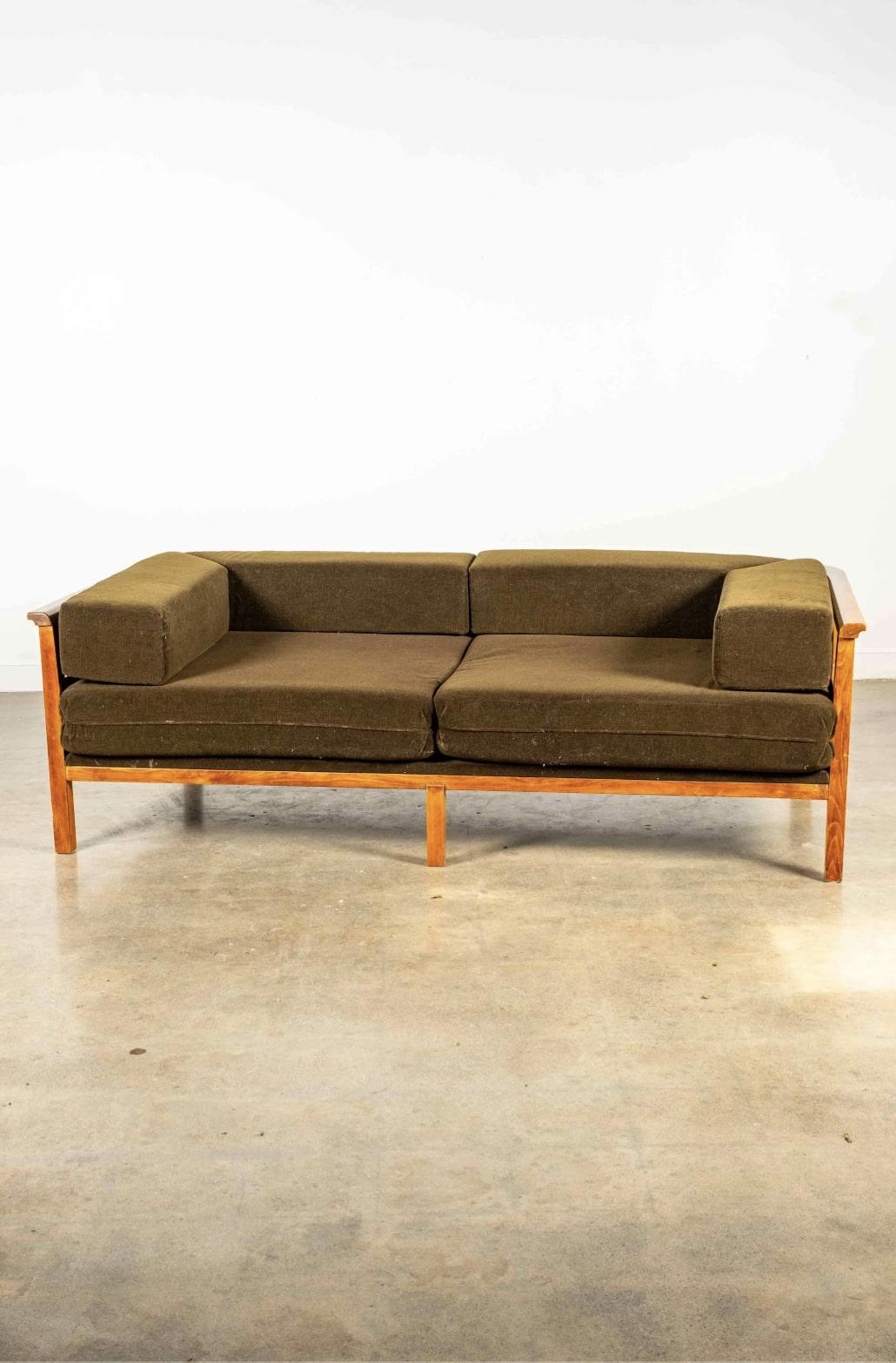 This sofa pairs loosely-stacked chocolate-brown cushions with a curved wooden frame, a combo that looks great from every angle. The frame’s brick-like pattern is eye-catching, countering the restful monochrome of the upholstery. A versatile piece,