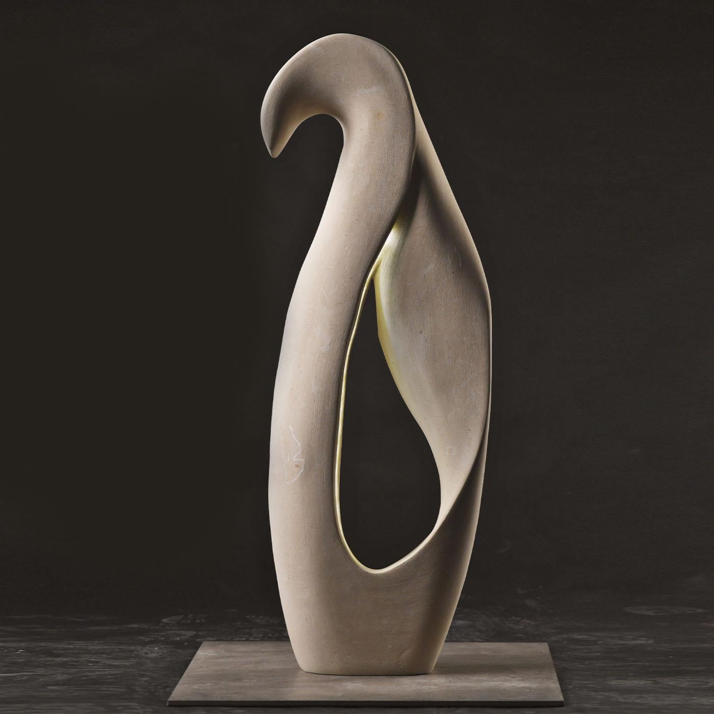 Wind softly blowing and seemingly shaping nature's shapes with its caress inspired this singular luminous sculpture signed by artist Andrea Serra. Handcrafted of a marine-origin white stone rich in vegetable and animal fossils that can only be