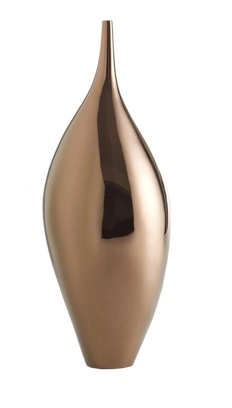 This sophisticated ceramic vase was entirely made by hand and poetically evokes the breath of life. It features a polished bronze finish whose smooth texture enhances the elongated lines of its delicate silhouette and gives a warm glow to its
