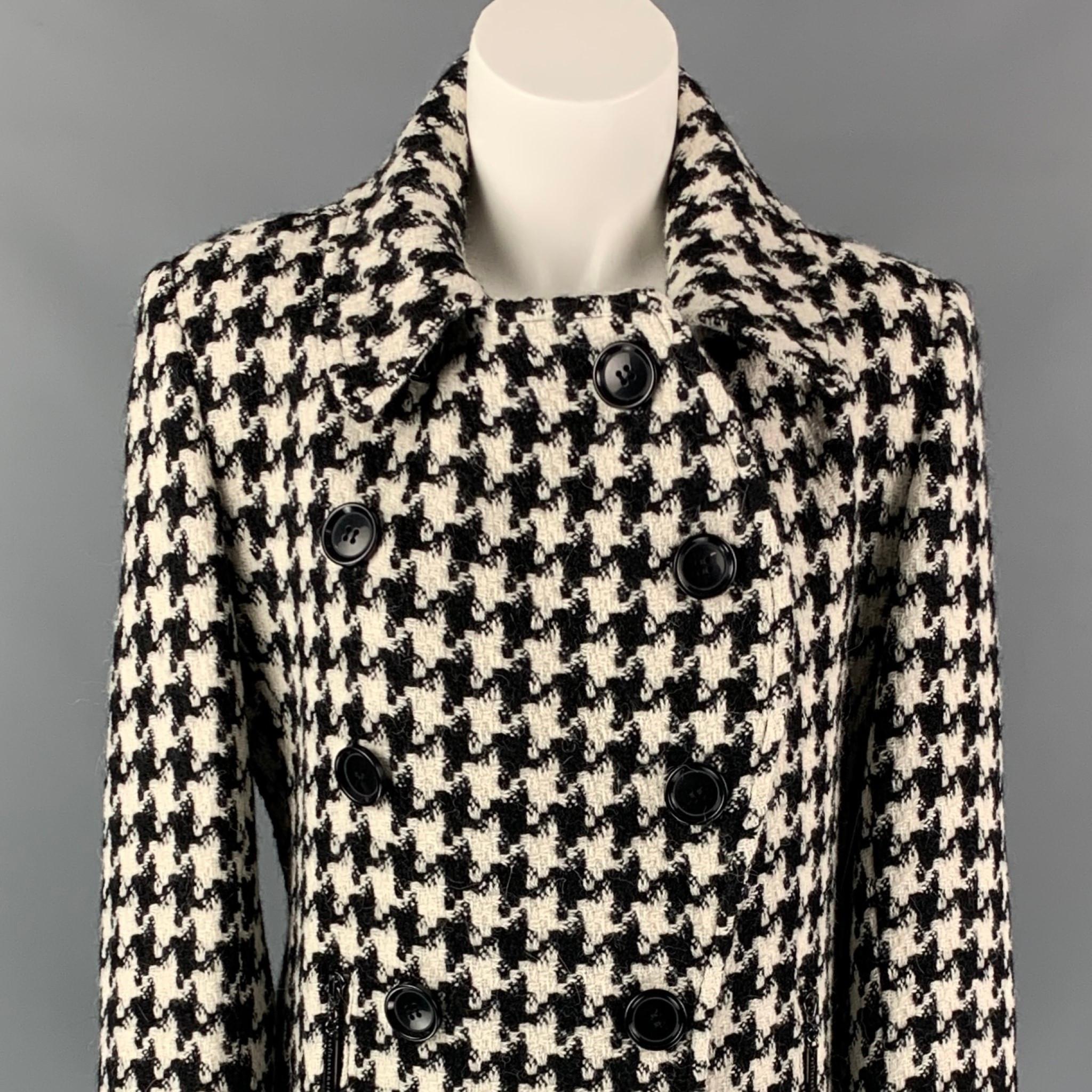 SOFIA CASHMERE coat comes in a black & white houndstooth alpaca / wool with a full liner featuring a large collar, zipper pockets, back strap, and a double breasted closure. 

Very Good Pre-Owned Condition.
Marked: 6
Original Retail: