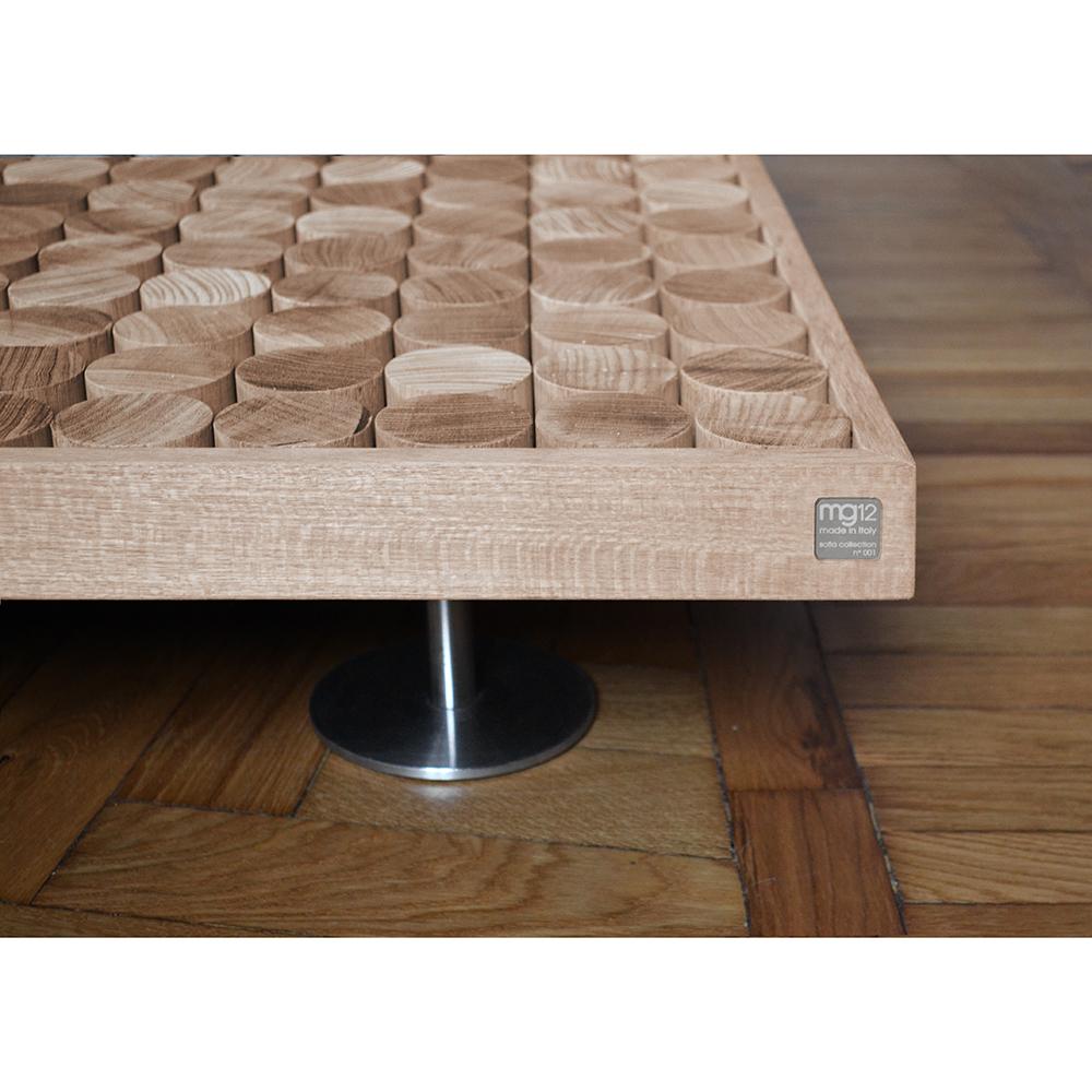 Made by master carpenters using artisanal techniques, each coffee table of this series is a one-of-a-kind piece that is numbered and signed. Its simple frame is highlighted on the surface by wood cylinders that animate its texture, bringing it to