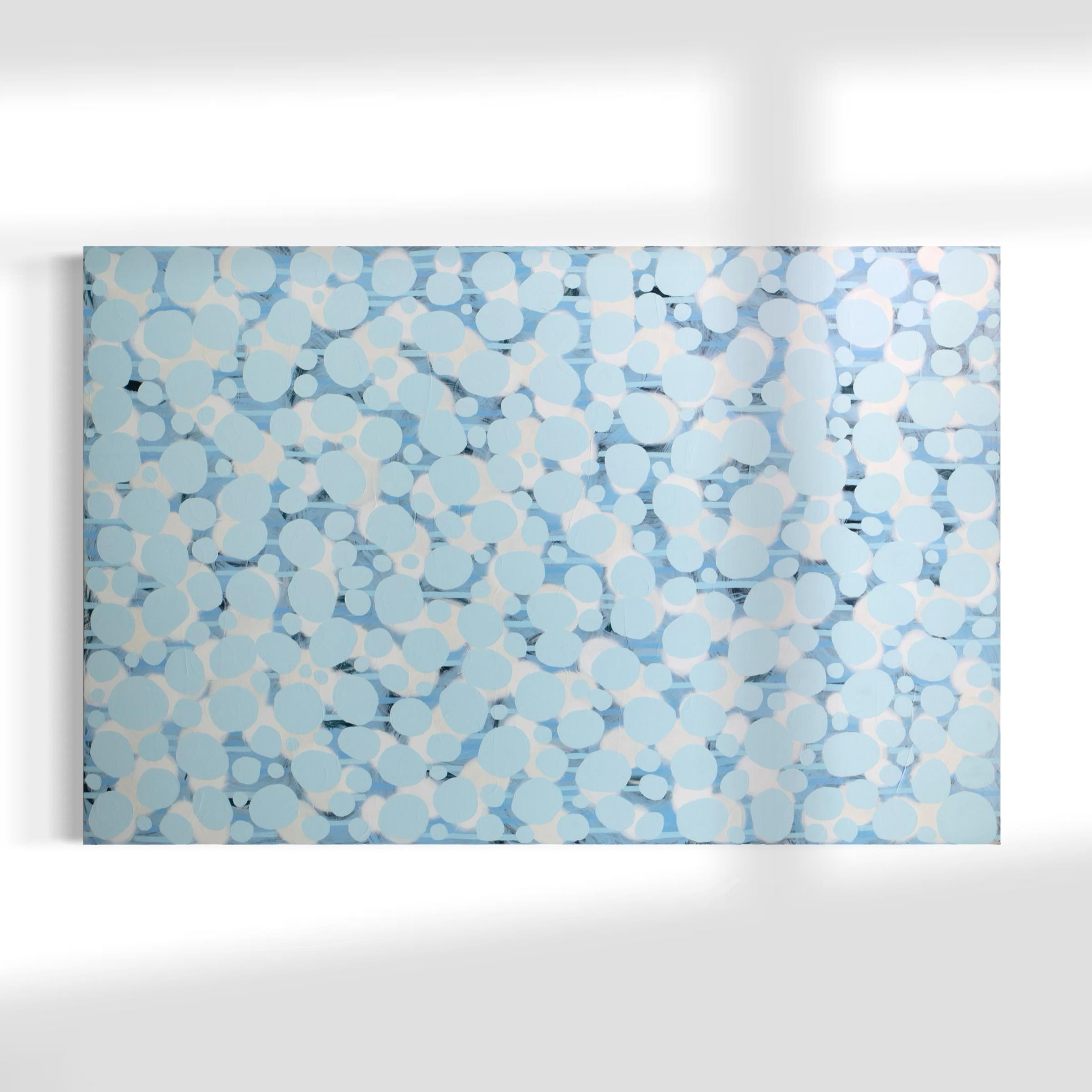 This large abstract statement painting by Sofie Swann features a light blue and white palette, with organic circular shapes layered throughout the canvas. This painting is made on gallery wrapped canvas with painted sides. It is signed by the artist