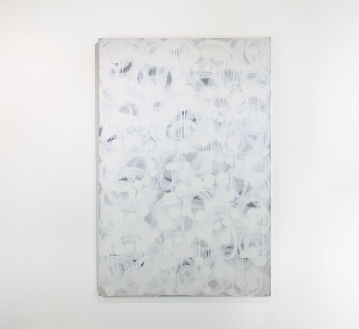 This large abstract statement painting by Sofie Swann features a white and light grey palette, with loose brush strokes which in energetic concentric circles throughout the canvas, layered over smaller white circle shapes. This painting is made on