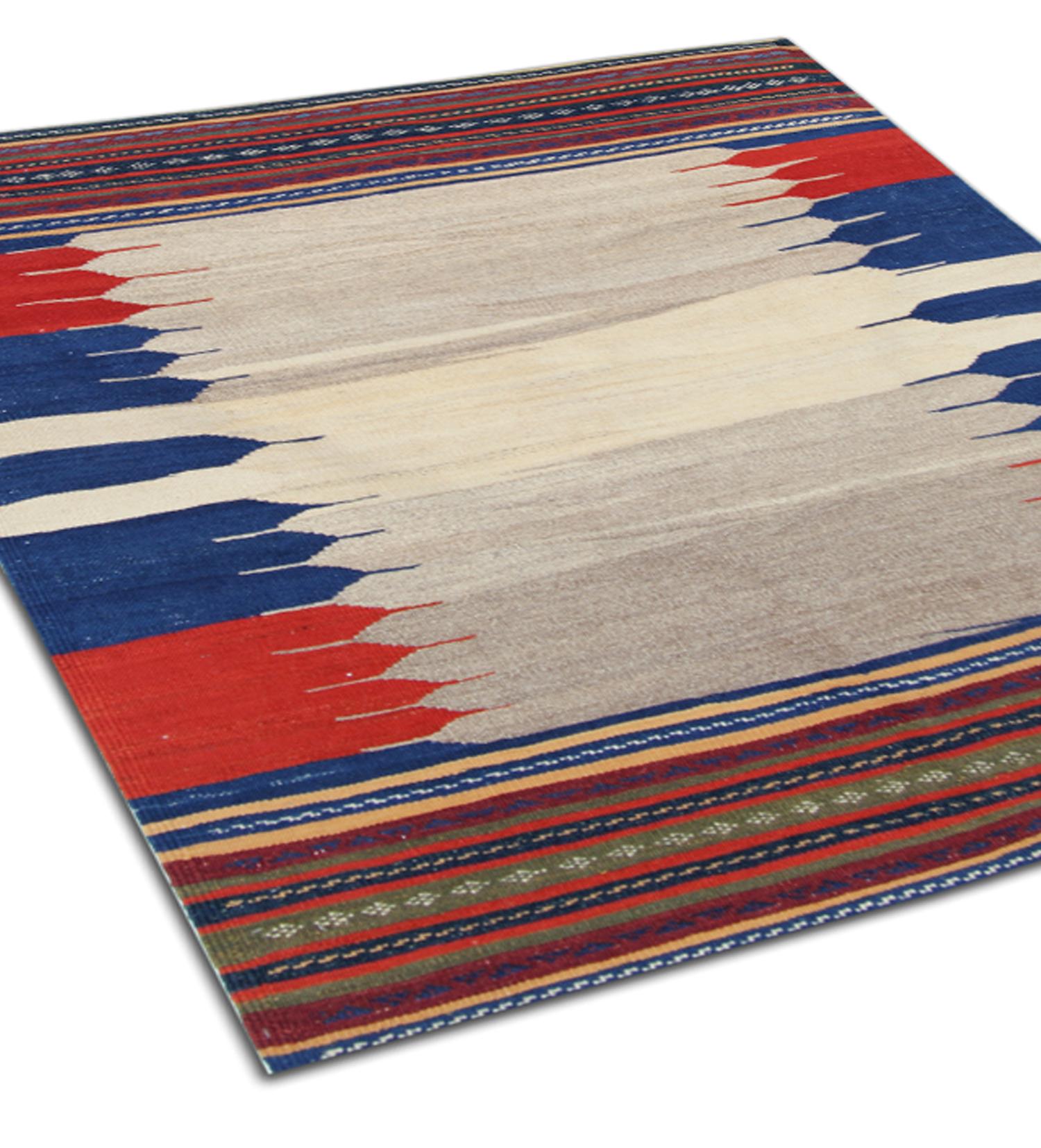 This vintage oriental kilim is a great example of Minimalist kilims woven in the 1940s. It has been handwoven with a simple colour palette including colours red, blue and ivory. With a simple block colour/ striped design. Constructed using hand-spun