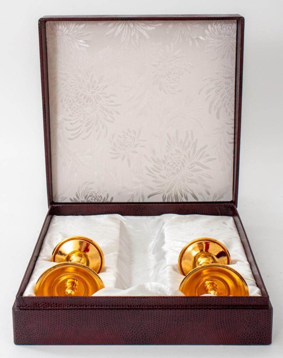Pair of shaded enameled gilt metal candlesticks by the Sofrino Co., Moscow, 1990s, within original presentation box bearing the cypher of Patriarch Alexey II [Ridiger] of Moscow and All Russia (Russian, 1929-2008), one candle stick stamped 