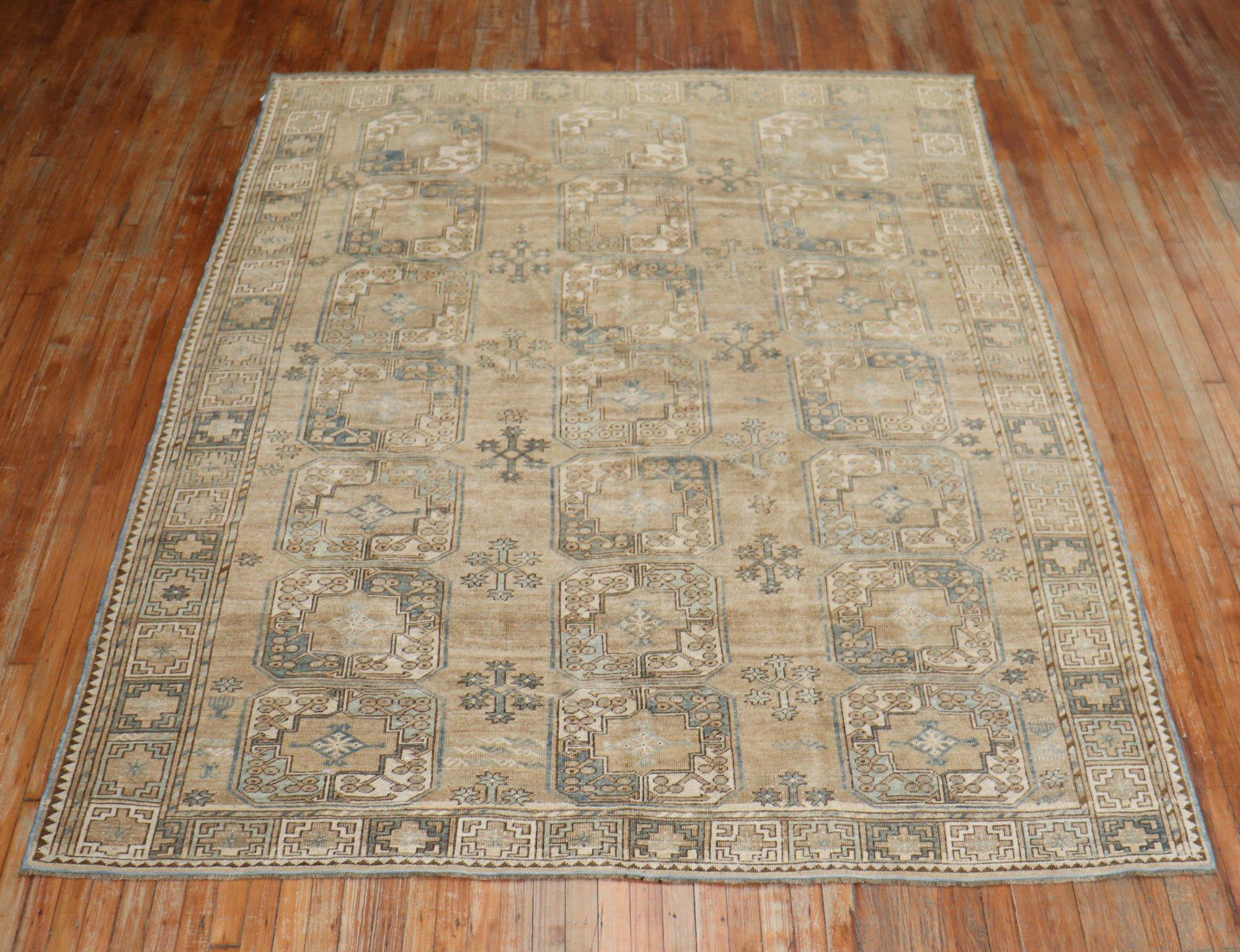 A 20th century one of a kind afghan Ersari rug with an all-over tribal motif on a soft brown field, accents in beige, denim blue, and gray

Measures: 7'4'' x 9'8''.