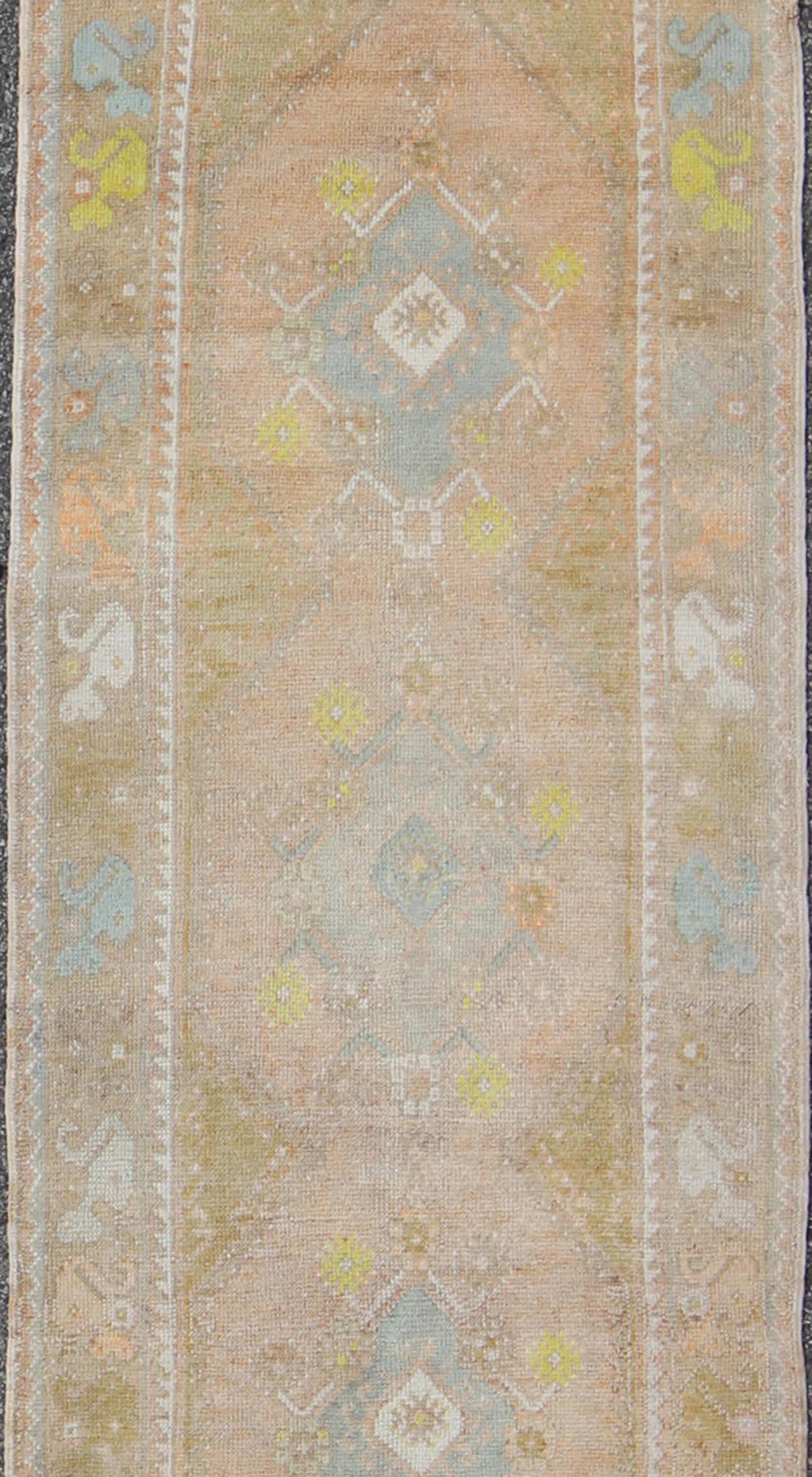 Watercolor Turkish Oushak Runner, rug EN-165867, country of origin / type: Turkey / Oushak, circa 1940

This vintage Turkish Oushak runner features four layered medallions expanding across the central field. The surrounding border features a