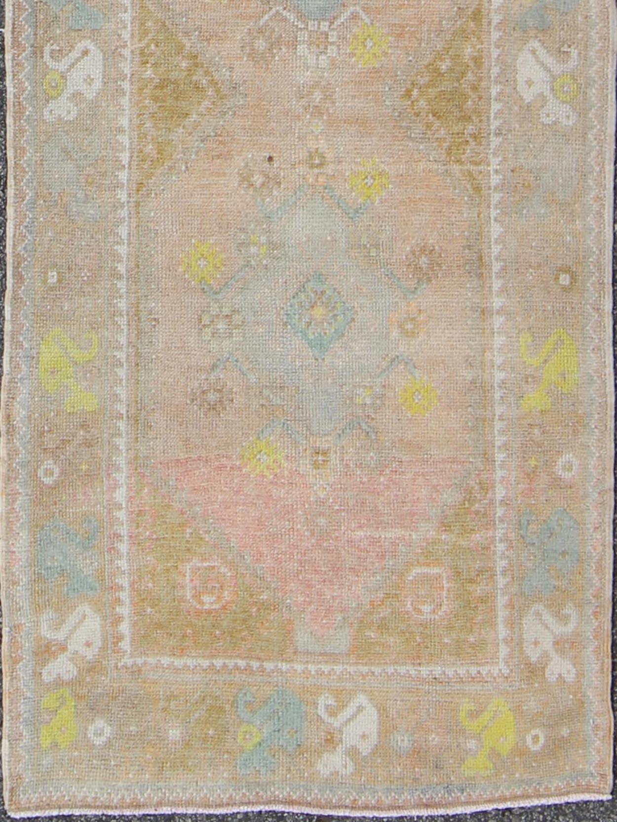 Hand-Knotted Soft Colors Vintage Turkish Oushak Runner with Four Medallion Design For Sale
