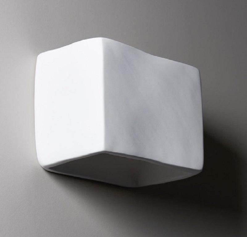 Handmade 'Soft Cube' organic modern wall light or wall sconce, in silky smooth white plaster, created by artist Hannah Woodhouse in her London studio. Contemporary organic modern design inspired by nature and midcentury European sculpture. The