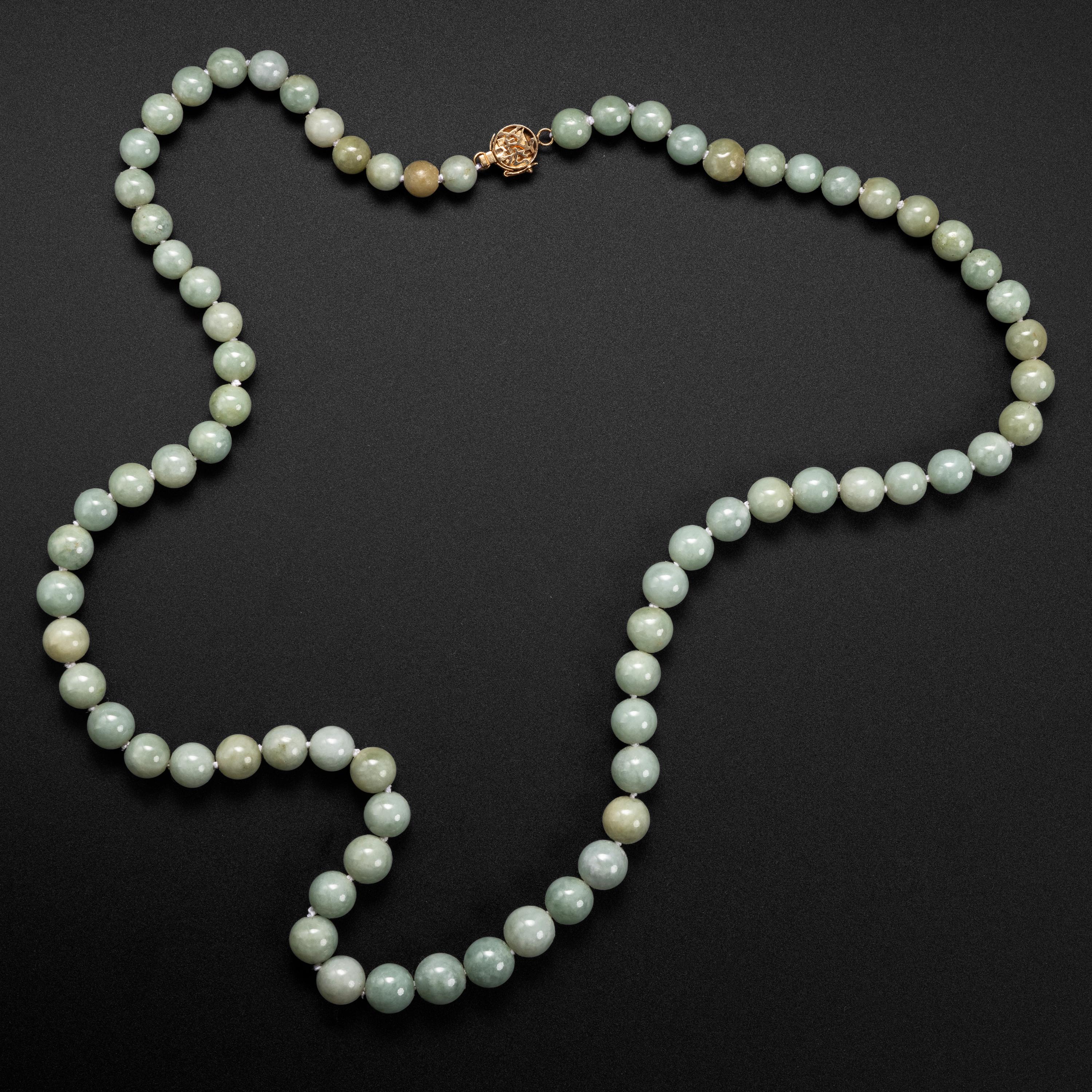 In soothing tones of light green and pale honey, this circa 1970s necklace is a statement of muted sophistication. The necklace measures 27