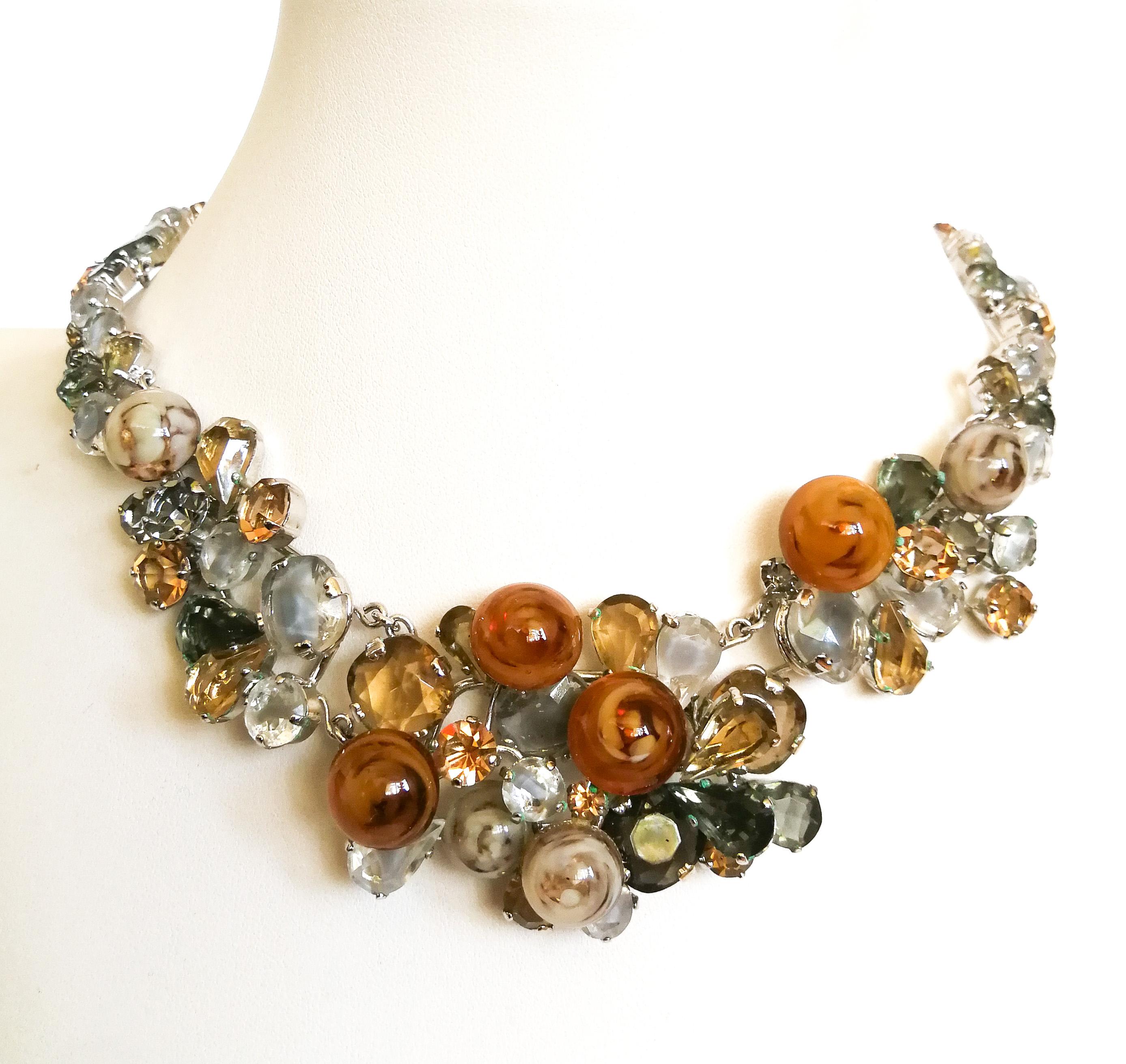 A very rare and important necklace from 1958, designed by Yves Saint Laurent, during the first year of his tenure at the House of Dior. Formed of swirled glass 'buttons' or 'bubbles' which sit atop of a melange of shaped pastes in subtle and soft