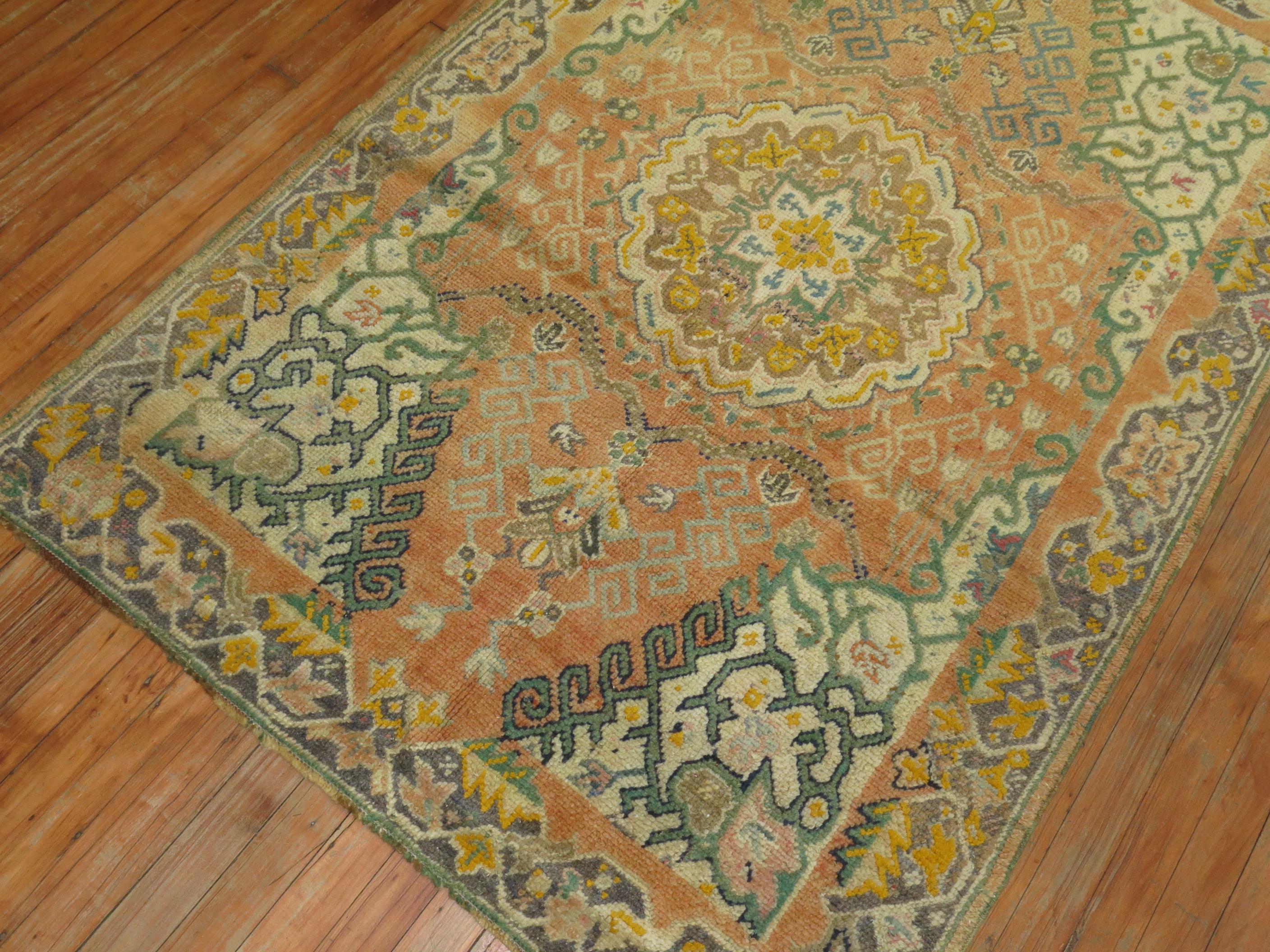 A early 20th century antique Turkish Oushak rug in predominant orange accents.