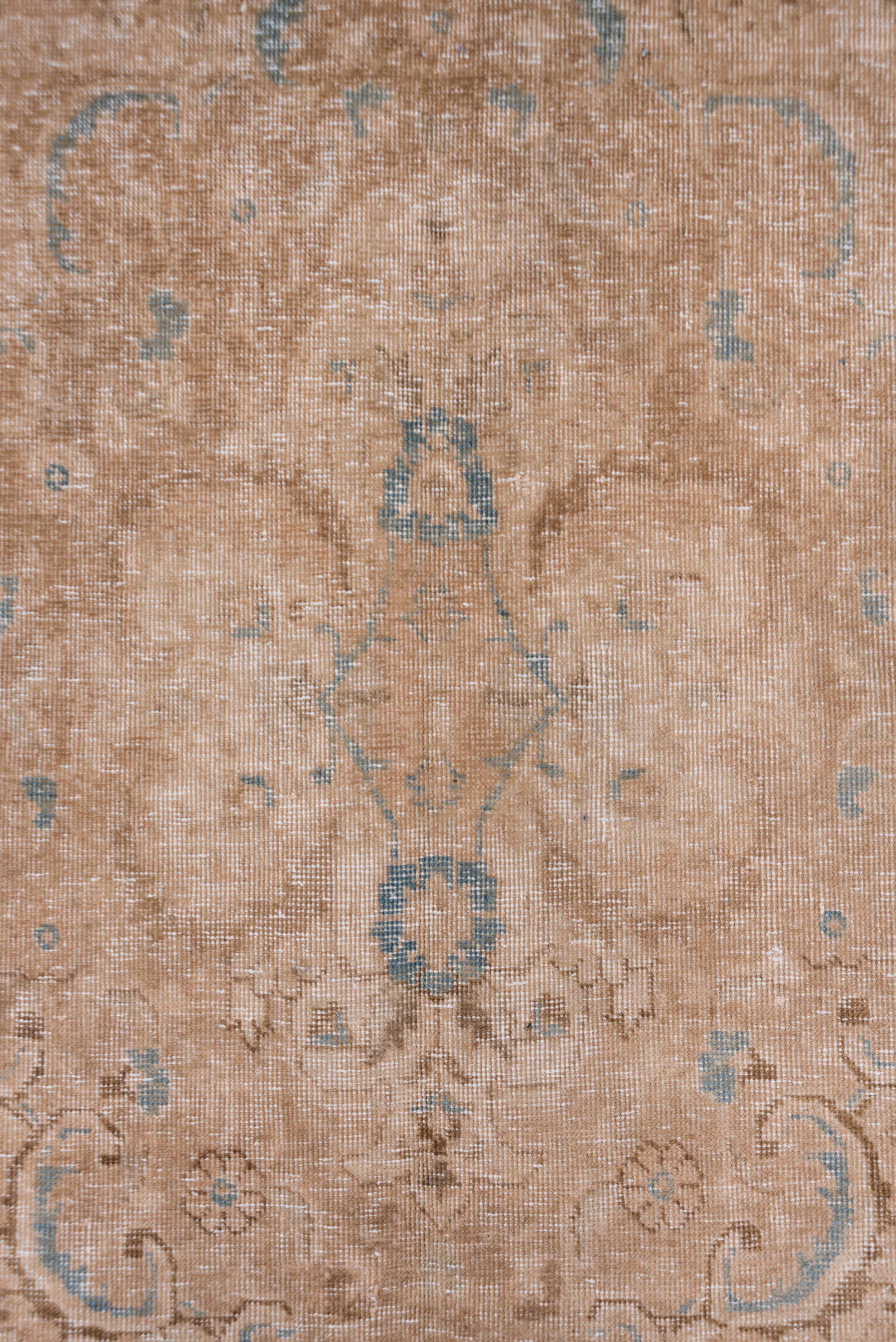 This generally distressed, flat NW Persian city carpet shows an open peachy-brown field with an acanthus- scalloped and pendanted medallion within a beige to brown main border of acanthus leaves and bottle shapes.