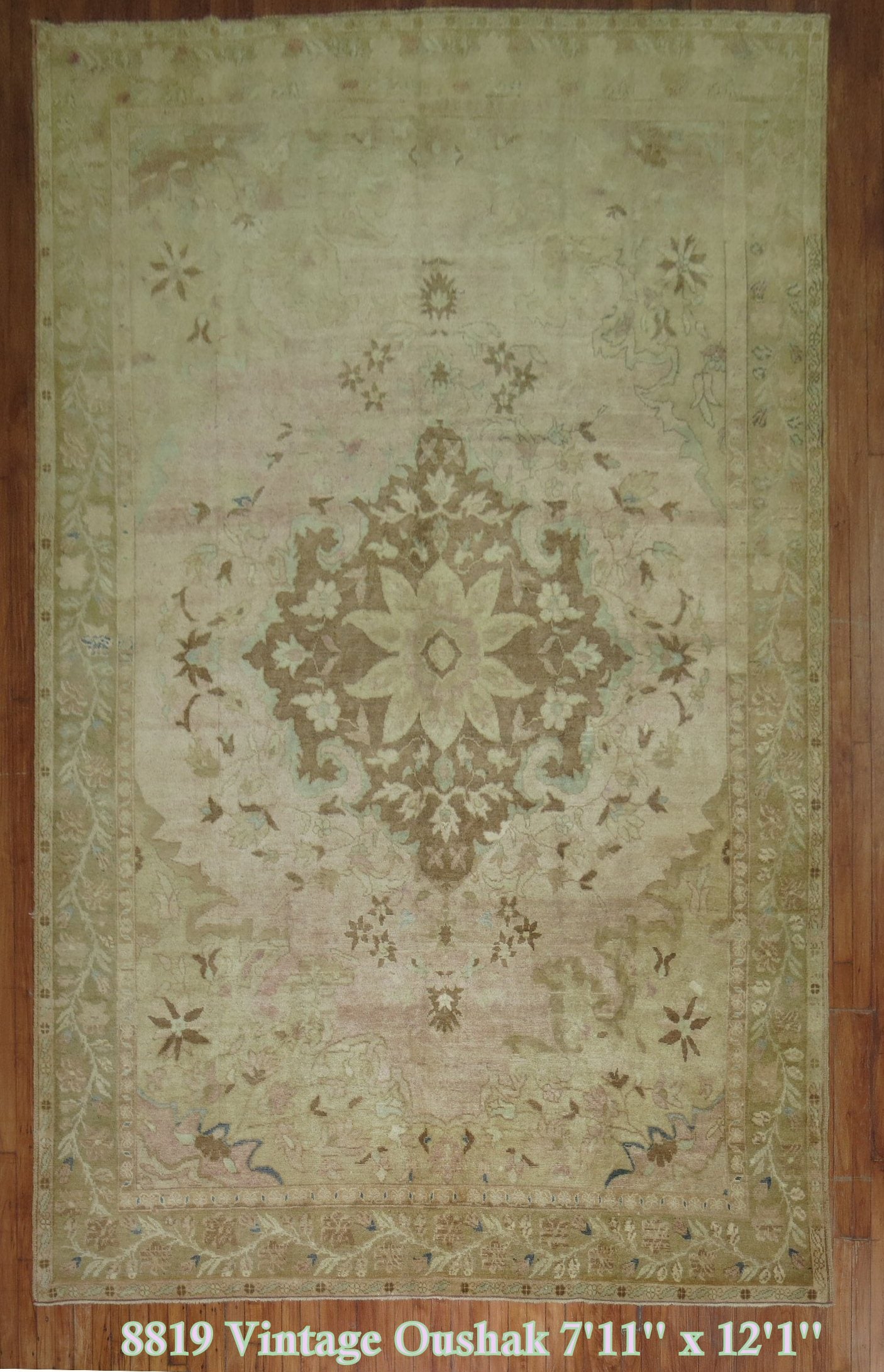 A room size vintage Turkish rug with a central medallion on a light pink field.

Measures: 7'11'' x 12'1''.