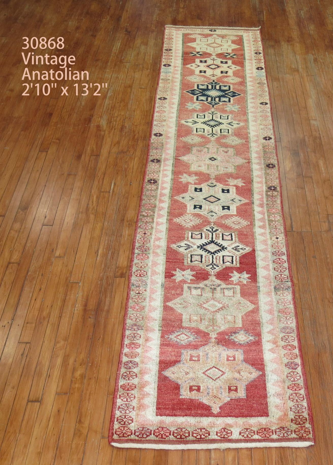 Mid 20th century Turkish Anatolian runner with a traditional multi medallion and border design

Measures: 2'10'' x 13'2''.