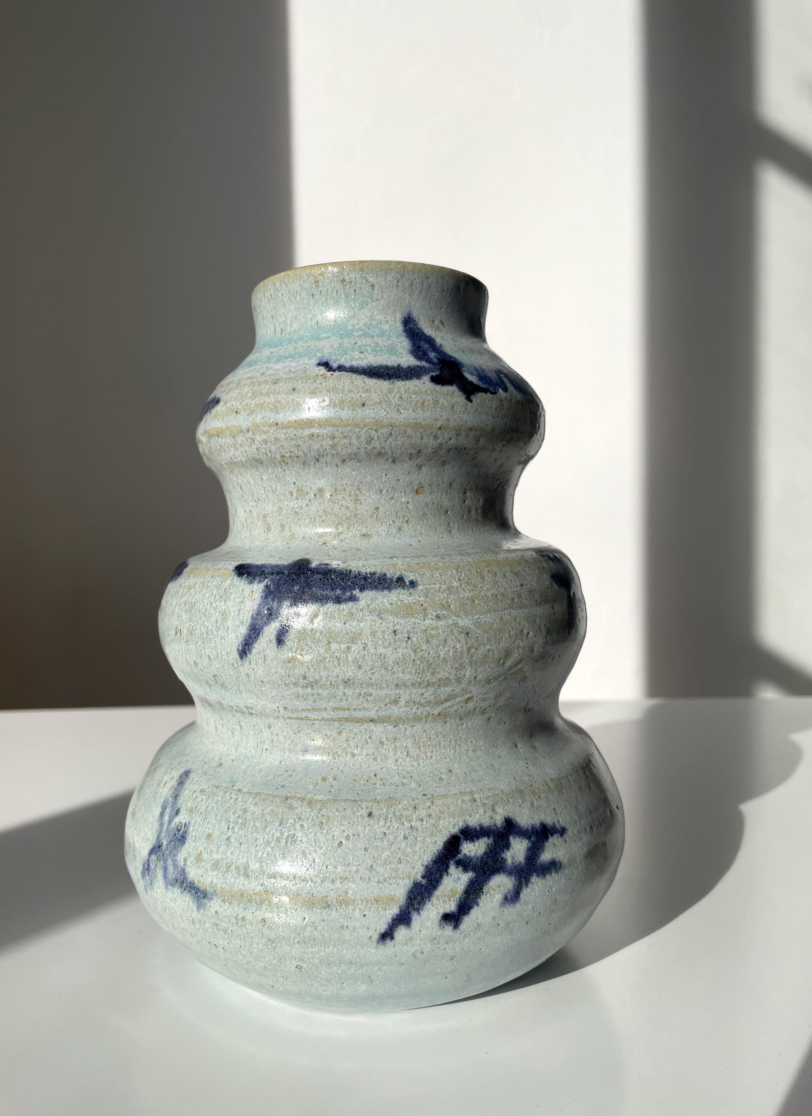 Vintage light blue handmade heavy ceramic vase with dark blue symbolic hand-painted decorations. Organic modern soft plumb tiered shape. Signed under base. Beautiful vintage condition.
Scandinavia, 1980s. 