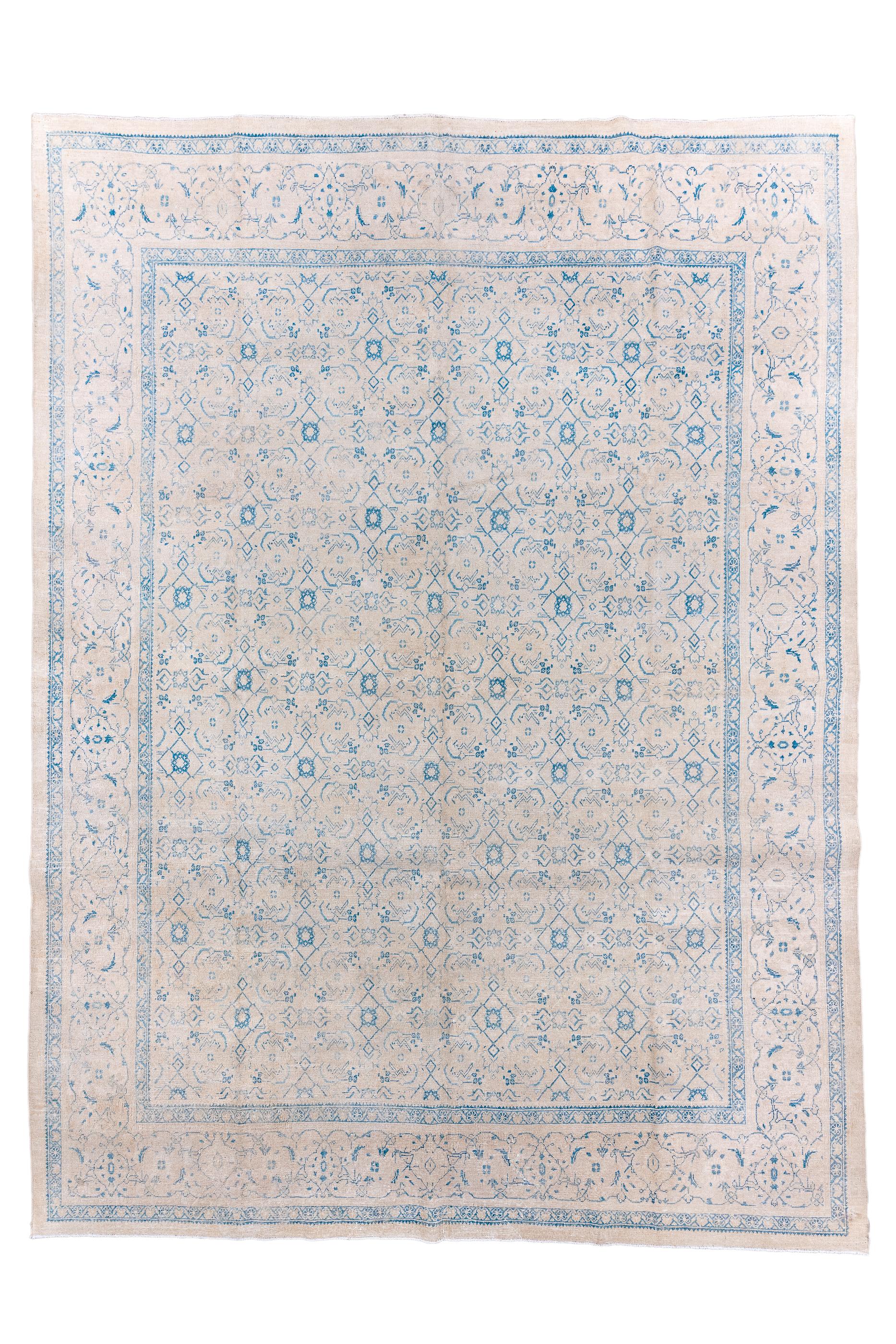 The soft buff field presents a small allover Herati design in blue with especially prominent offset rows of little rosettes. Light border of outline turtles trapped in a vine scrollerie. Plain tonally en suite outer surround. Moderate weave on
