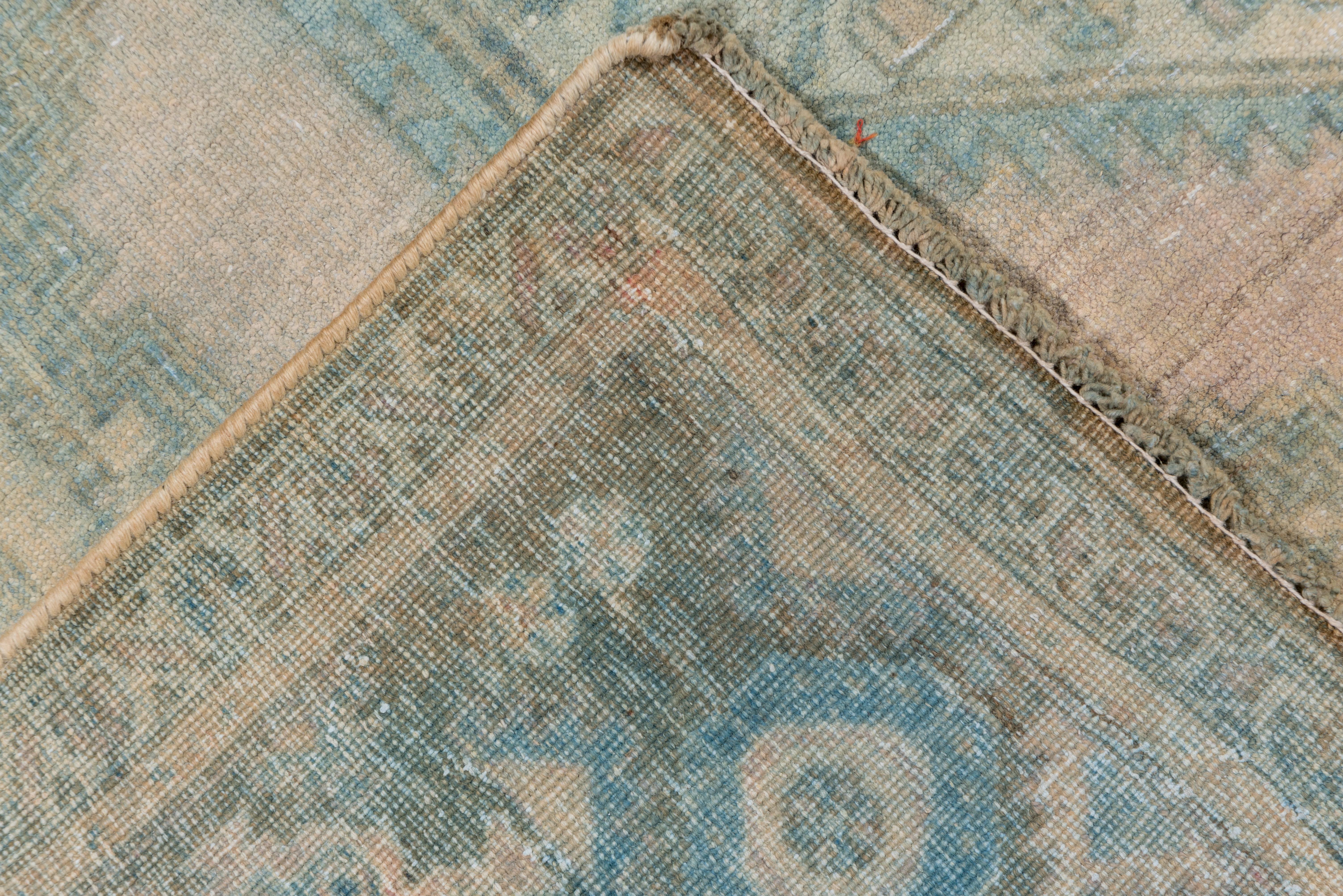 A bold zig-zag sets off the two cream octagons with central squares, on the straw open field. Greenish border with octofoil cartouches, rosettes and half ashiks. Medium tribal weave. From SE Persia. Fair condition with a softer tonality.