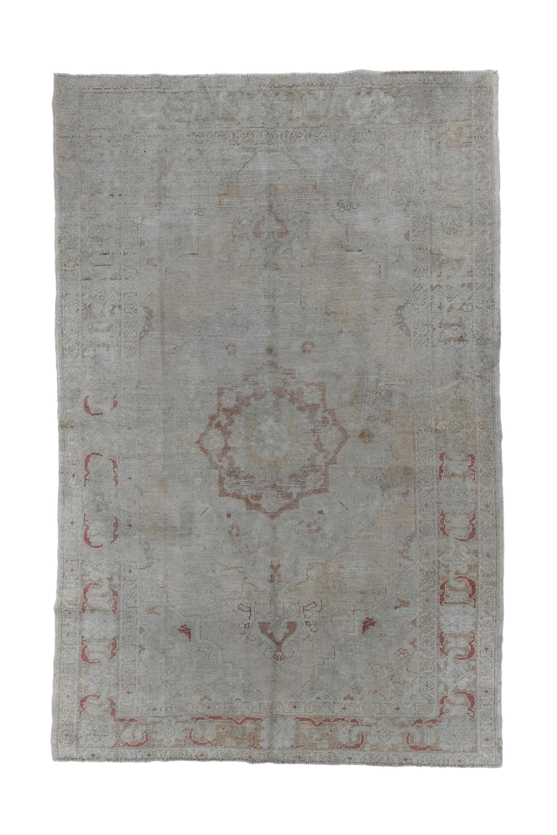 This softly-toned, large Anatolian scatter presents a brown octogramme medallion, with internal radiating flowers, and distant pendants.  Flowers are scattered and floating in the oatmeal field. Buff border interlocking beige and slate grey leaves.