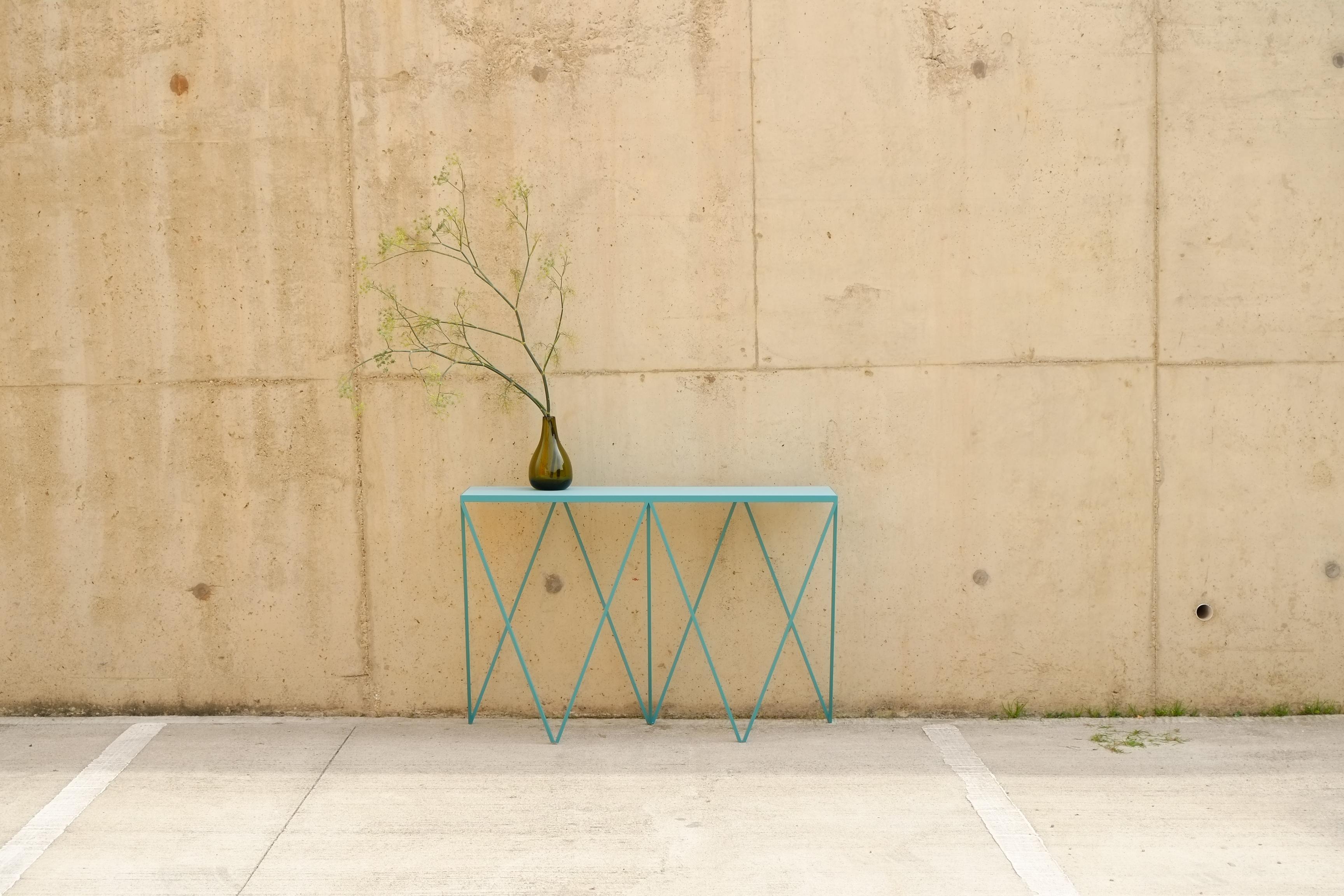 A beautiful soft turquoise Giraffe Console Table made with a powder coated steel frame and a color matched linoleum table top. The top is made out of environmentally friendly linoleum. The linoleum top is produced from a very finely ground linoleum