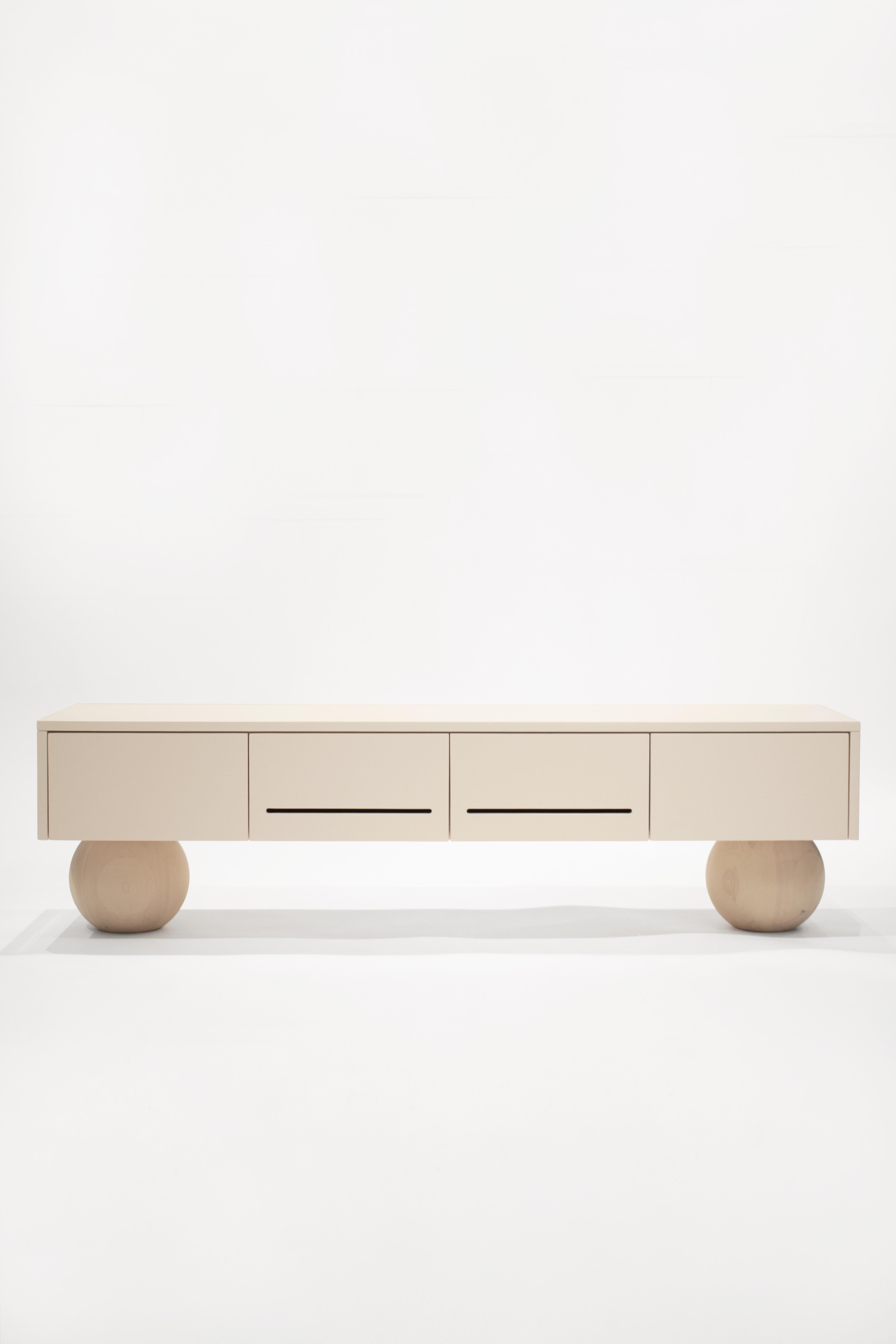 SOFT TV unit console in beige color and natural Swedish pine solid wood spheres.
With linear cuts on the front covers for giving access to remote control signals. A custom hole for cables can be made on the backside upon request.

The SOFT