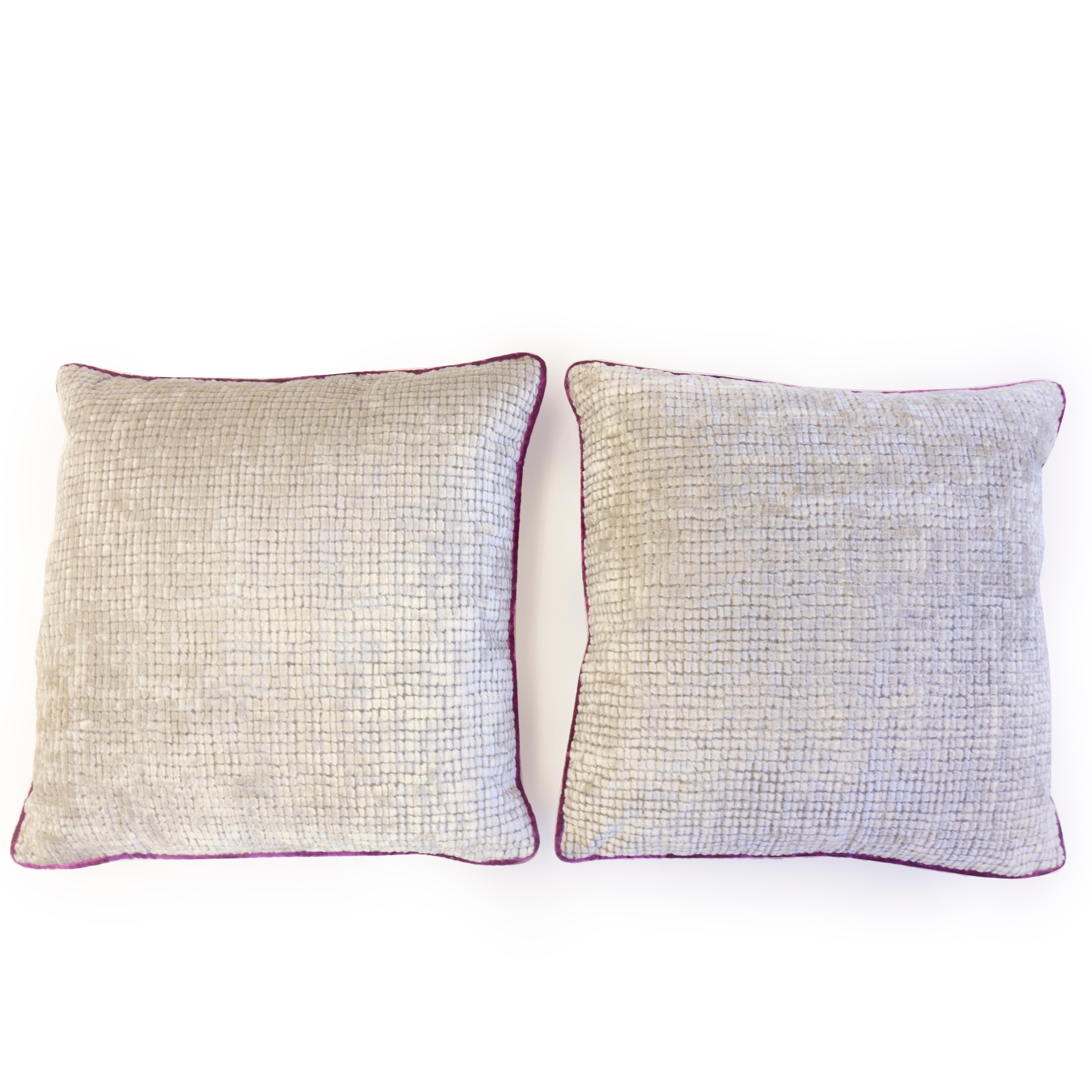These pillows were hand sewn at our studio in Norwalk, Connecticut. They feature a soft velvet square grid pattern on the front and a weaved fabric on the back that glimmers. Fuchsia piping borders the pillow. 

Measurements: 20