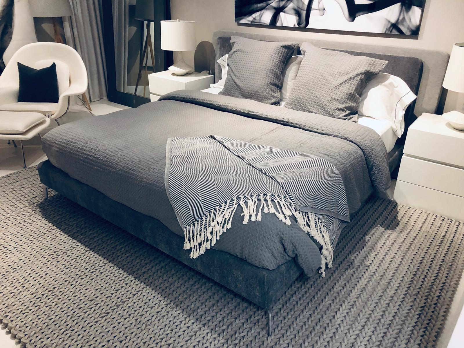 Elegant upholstered Italian bed, crafted with refined attention to detail and proudly Made in Italy. This model features a sophisticated dual-tone fabric design: a darker shade is used for the bed base and the headboard cushions, while a lighter