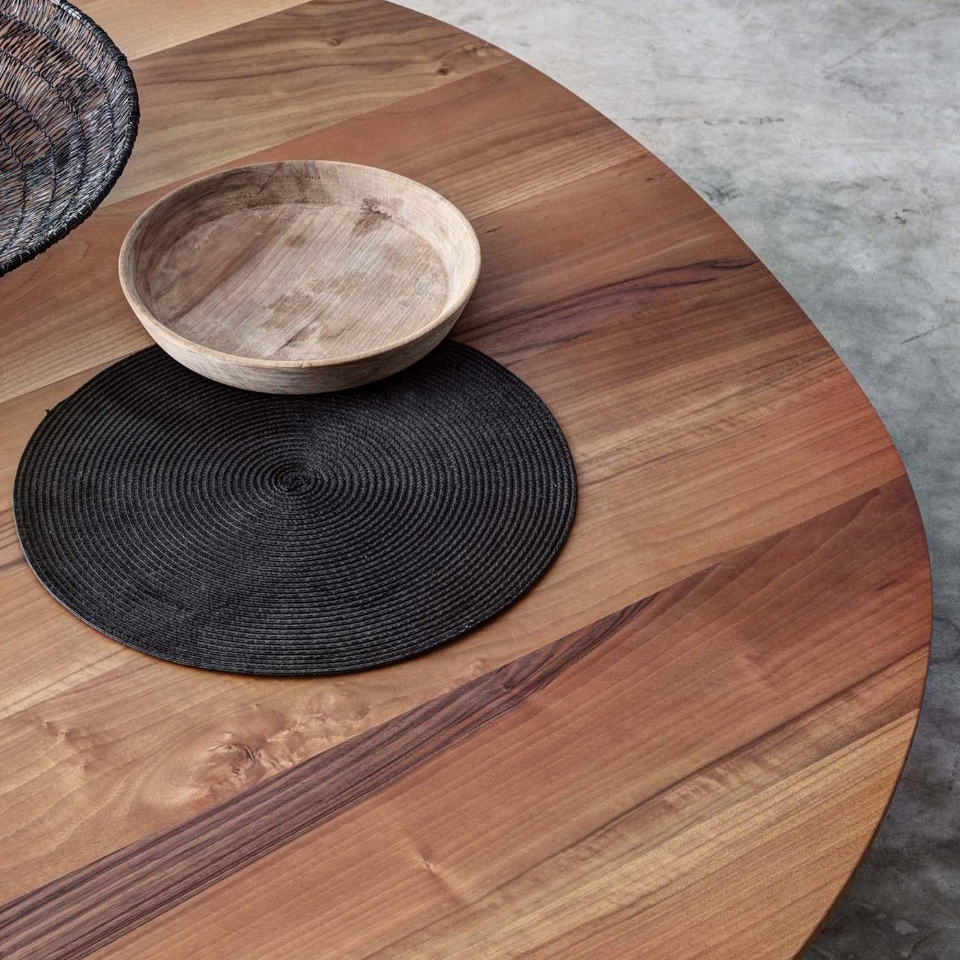 A magnificent addition to a modern living room, this coffee table was designed by Act_Romegialli. Its unique silhouette is enriched by the use of solid chestnut, whose warm hues and unique grain create the one-of-a-kind decoration of its top. Its