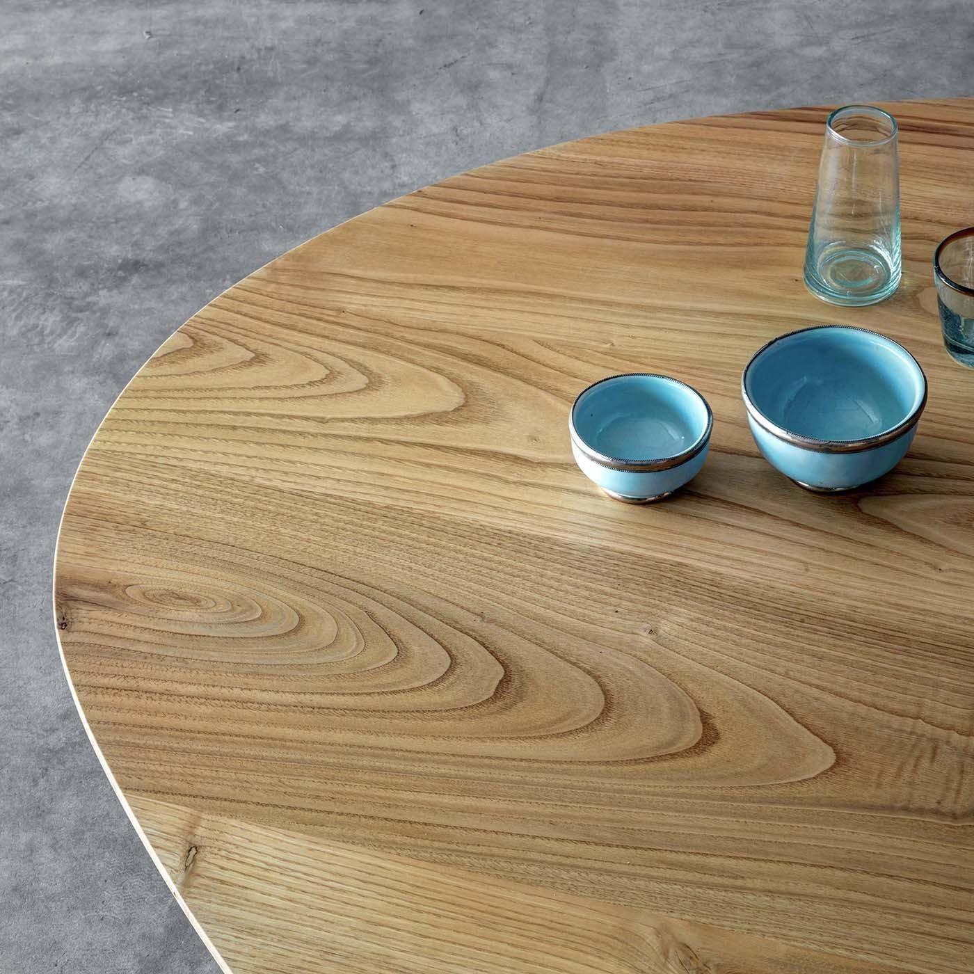 Designed by Act_Romegialli, this elegant coffee table will be the focal point of a modern or rustic interior, thanks to its superb solid walnut top and its unique silhouette. Shaped as an asymmetrical egg with tapered edges, the top is visually