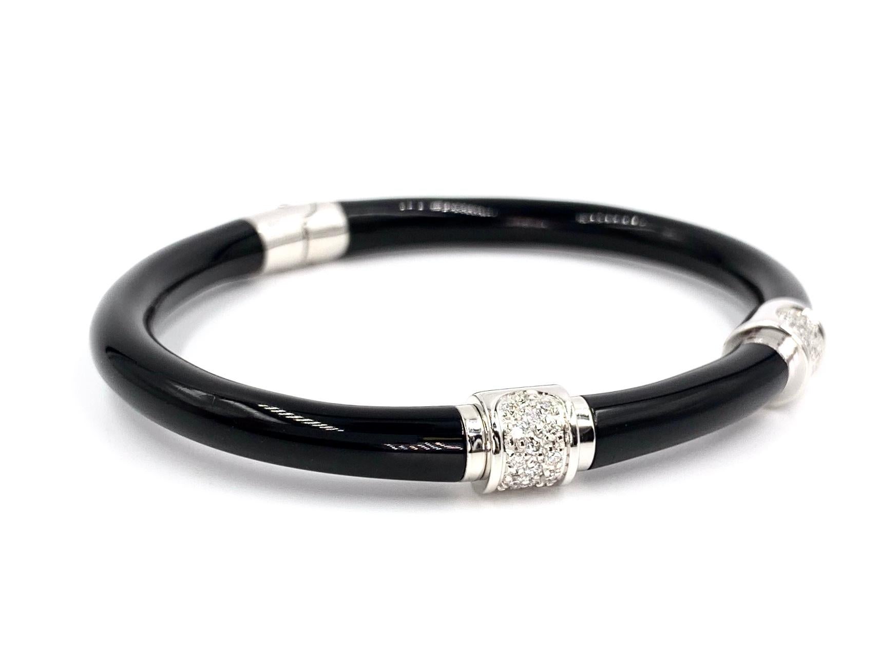 Handcrafted in Italy, SOHO jewelry features precious 18 karat white gold expertly overlaid with sleek and lustrous stark black enamel. SOHO enamel jewelry is known for it's durability and smooth feel. This wearable and modern oval bangle features