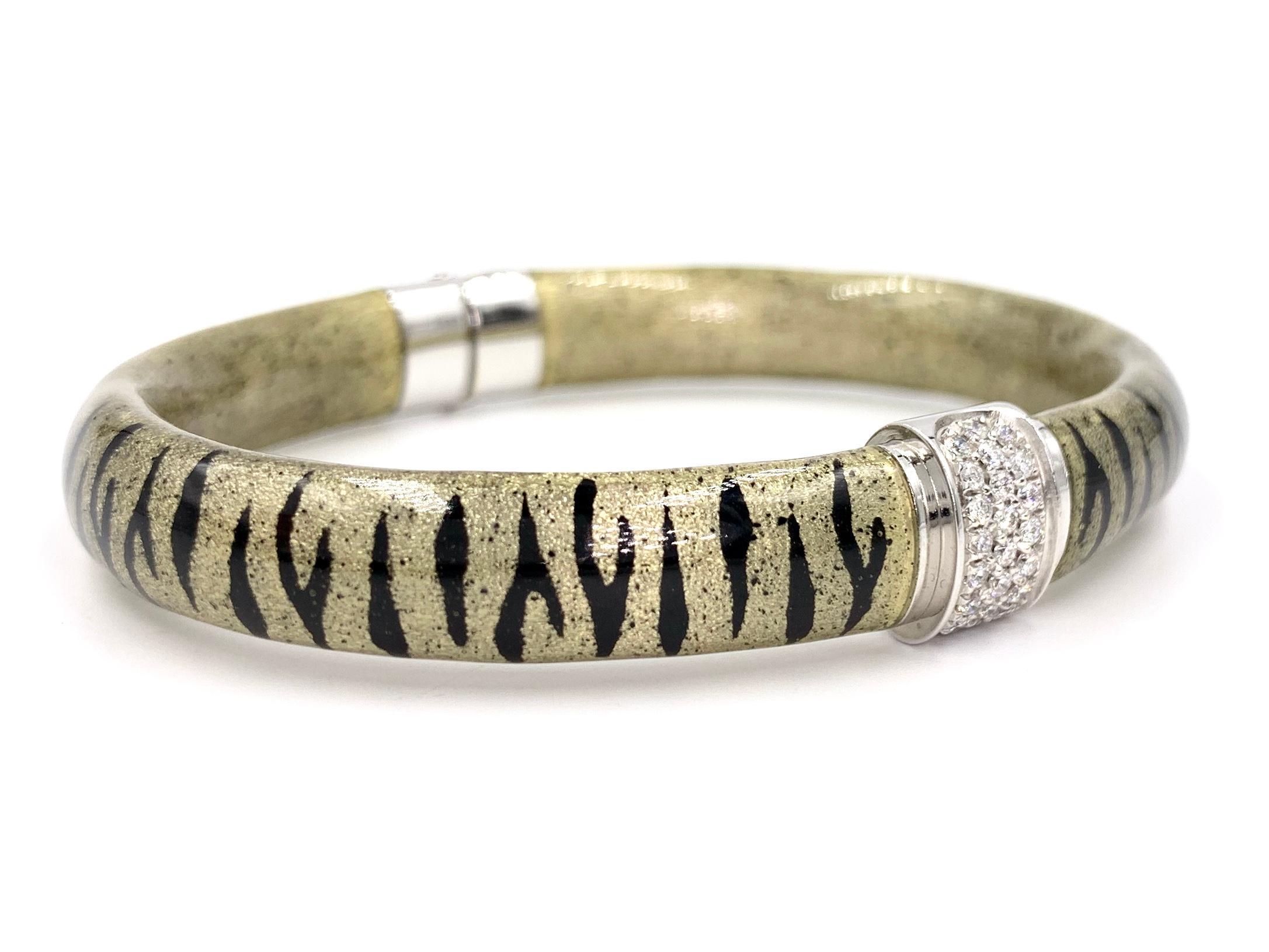 Handcrafted in Italy, SOHO jewelry features precious 18 karat white gold expertly overlaid with sleek and lustrous champagne and black tiger print enamel. SOHO enamel jewelry is known for it's durability and smooth feel. This 9mm wearable and modern