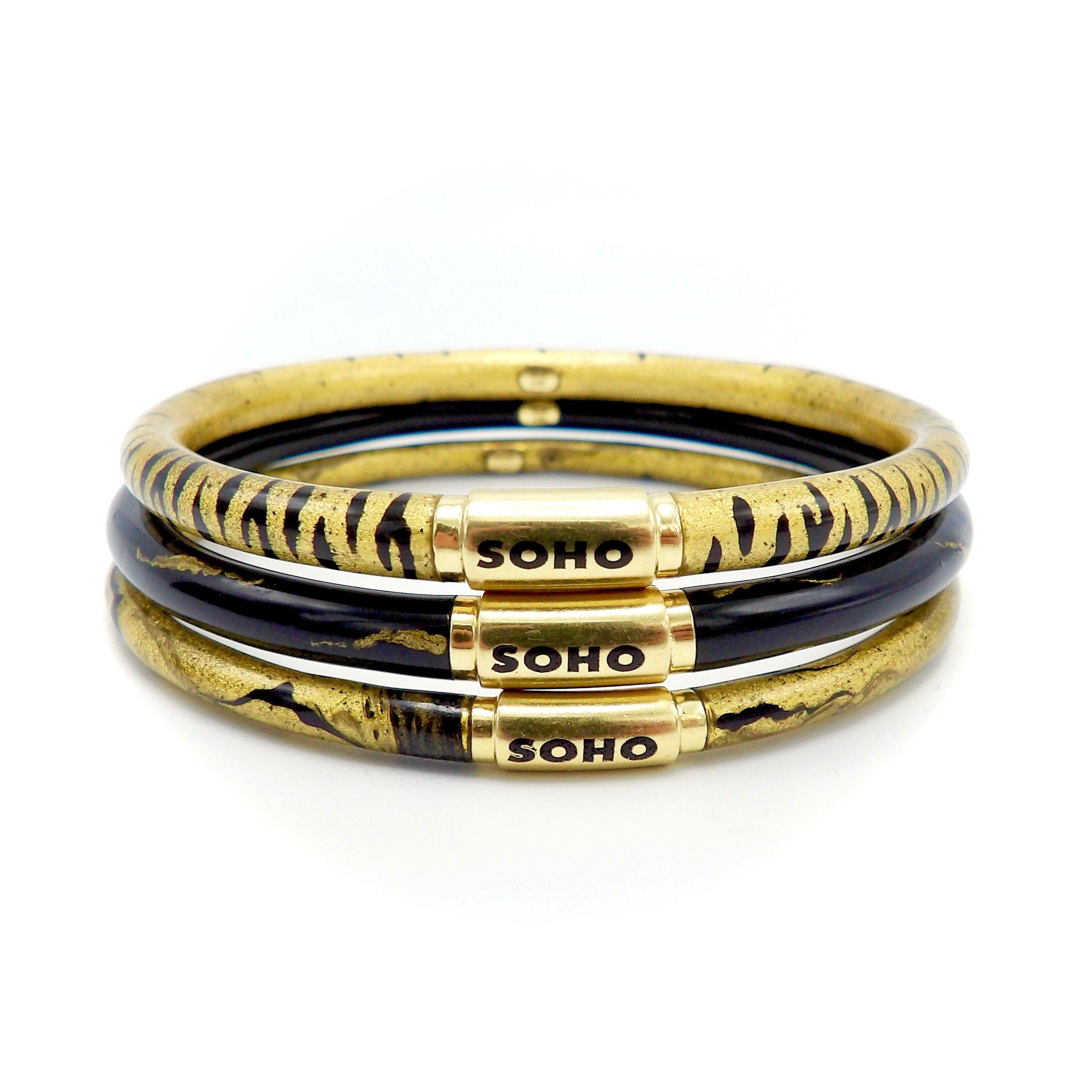 Women's Soho 18K Gold Black Enamel Calligraphic Stripe Bangle Bracelet, circa 2010 For Sale