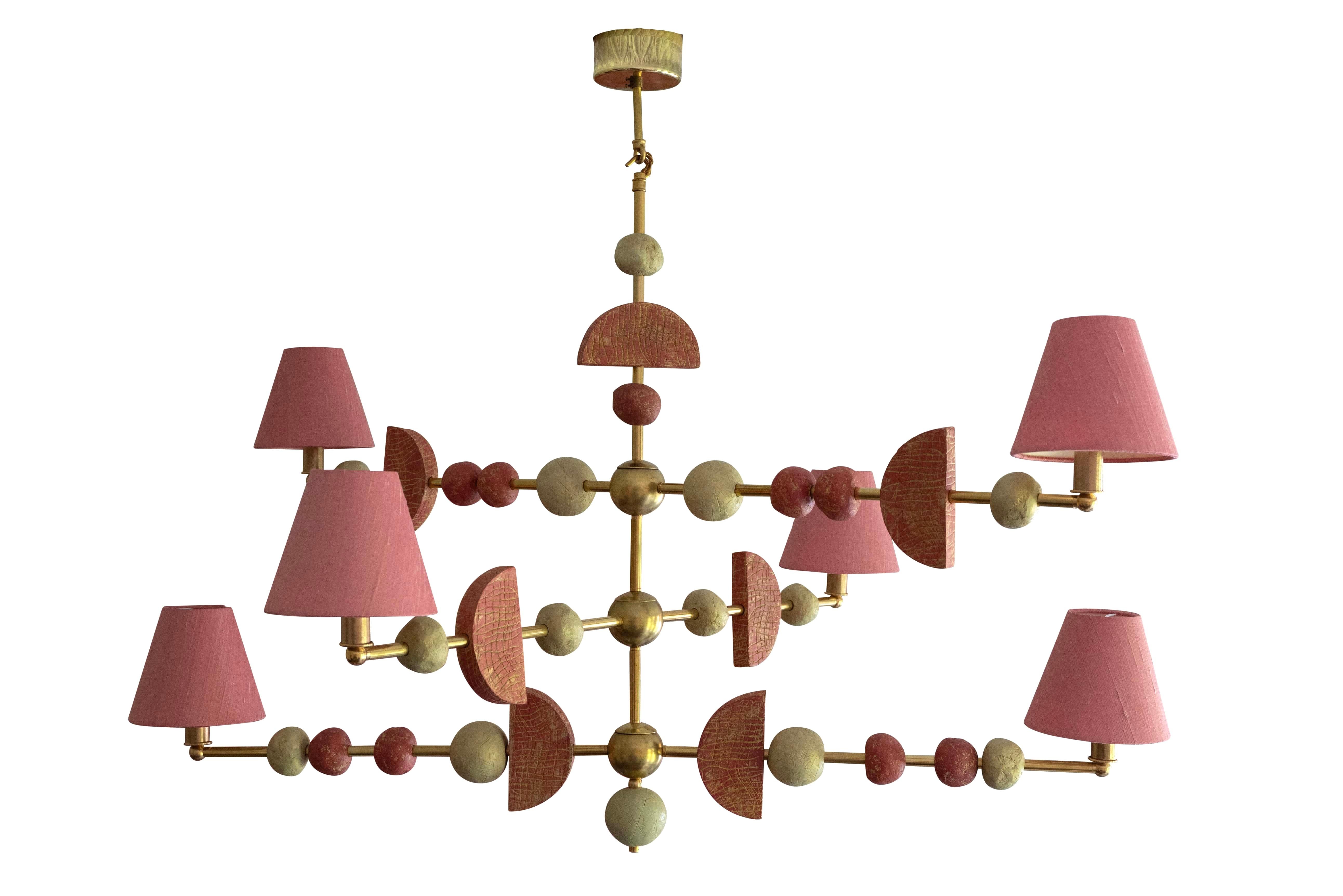 This contemporary three-tier chandelier by Margit Wittig features sculptural components with organic and subtle textures, all cast and treated with multiple layers of patina in her London studio. The contrast of a soft, dark blush-rose colour,