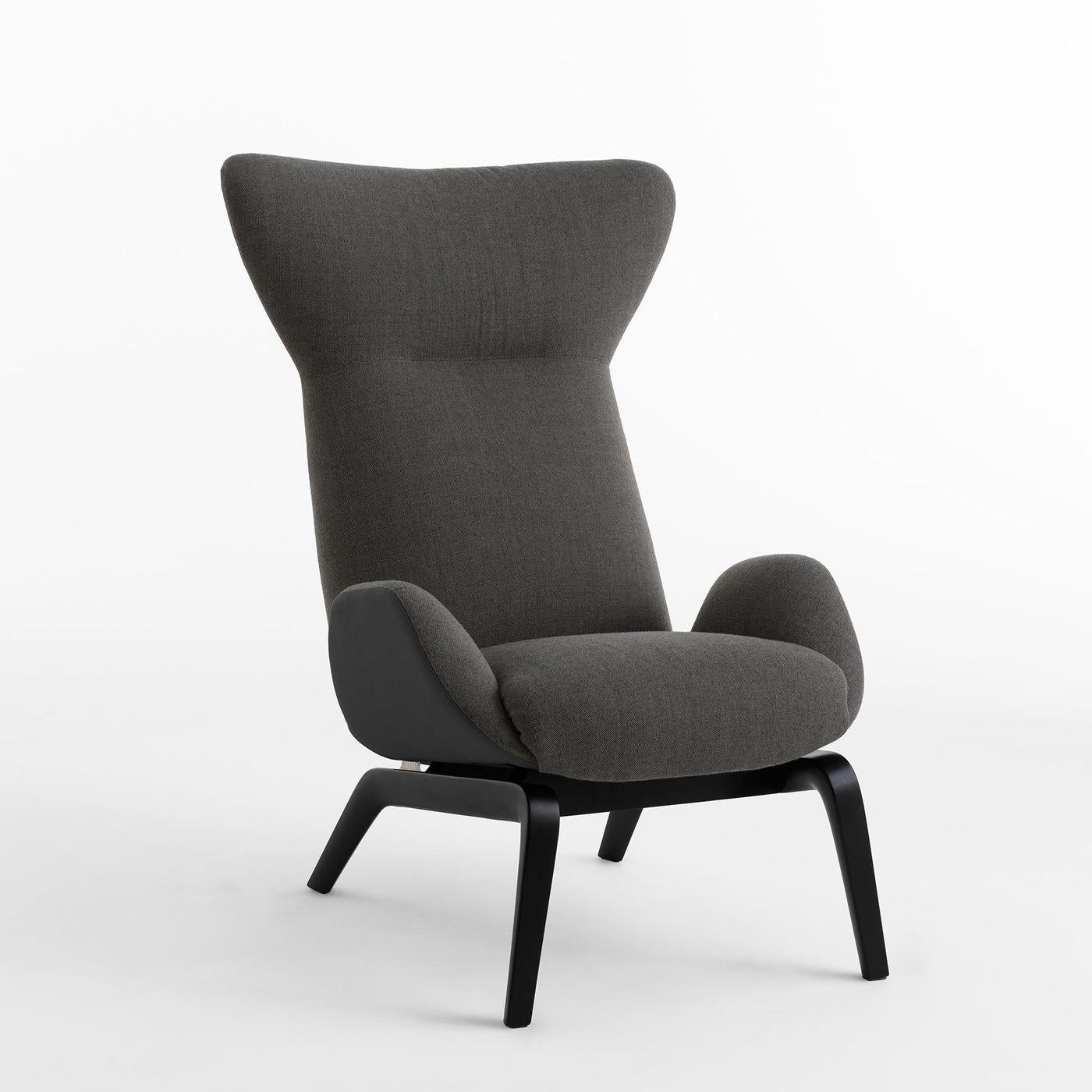 Inspired by Scandinavian style of interior design, this stunning armchair boasts gently curved lines and comfortable allure. Designed by Studio Balutto and crafted with meticulous attention to details, it comprises a black ash wood base with sturdy