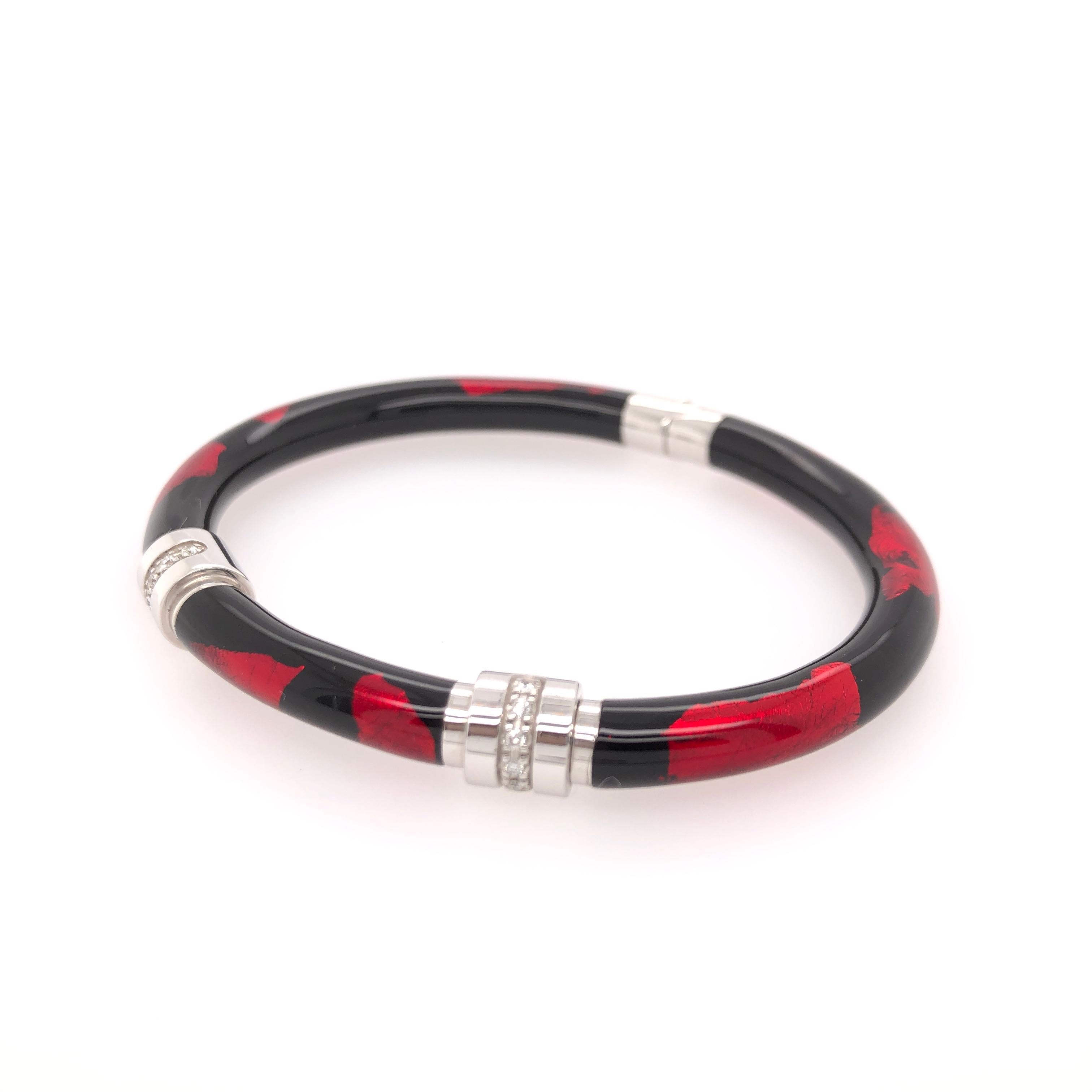 SOHO sterling silver and enamel red and black foliage bangle with two diamond stations.

Total estimated diamond carat weight: 0.32 CT

Stamped: SOHO SLVR