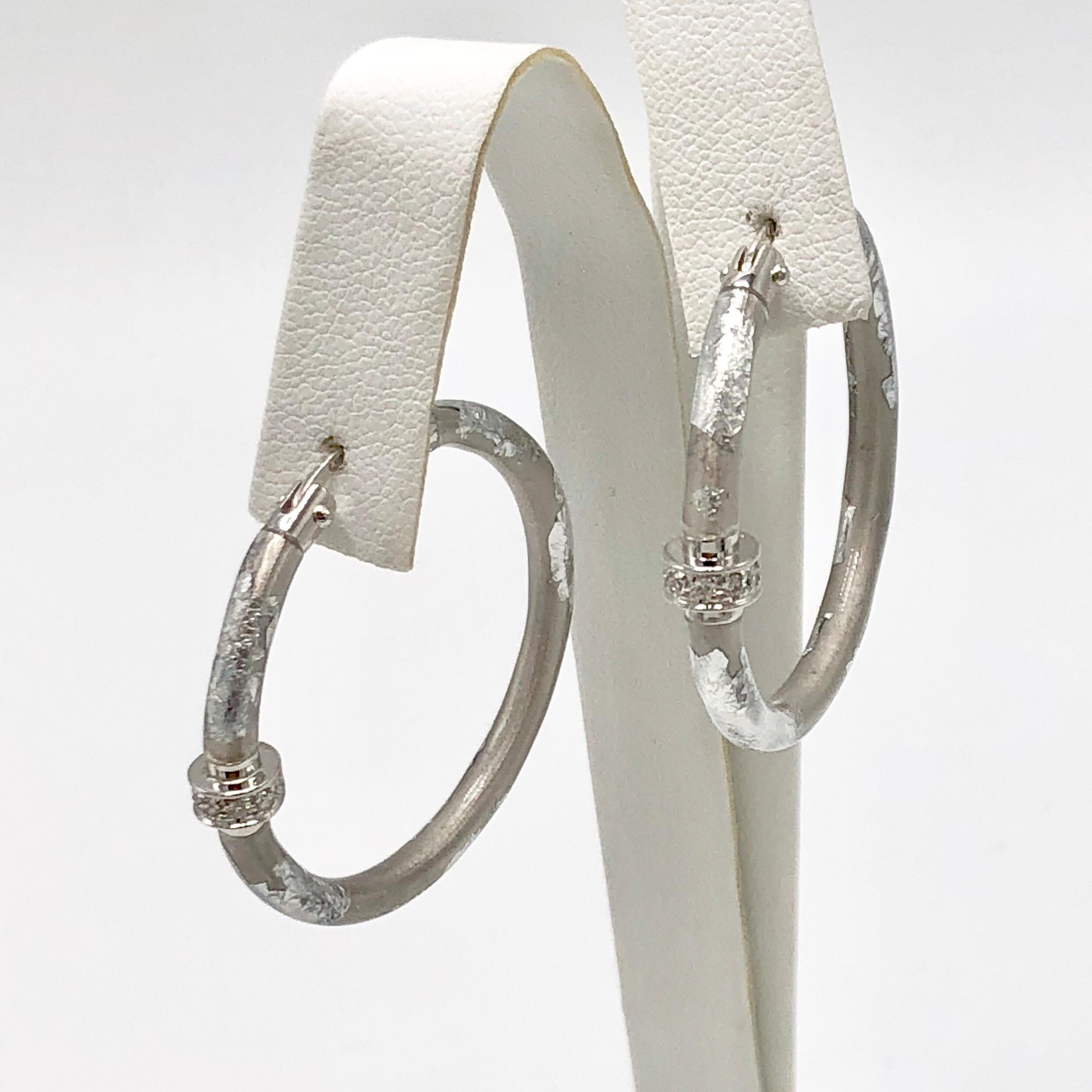 Silver foliage hoop earrings over sterling silver with a diamond station on each earring. 
Stamped '925 Italy'.
