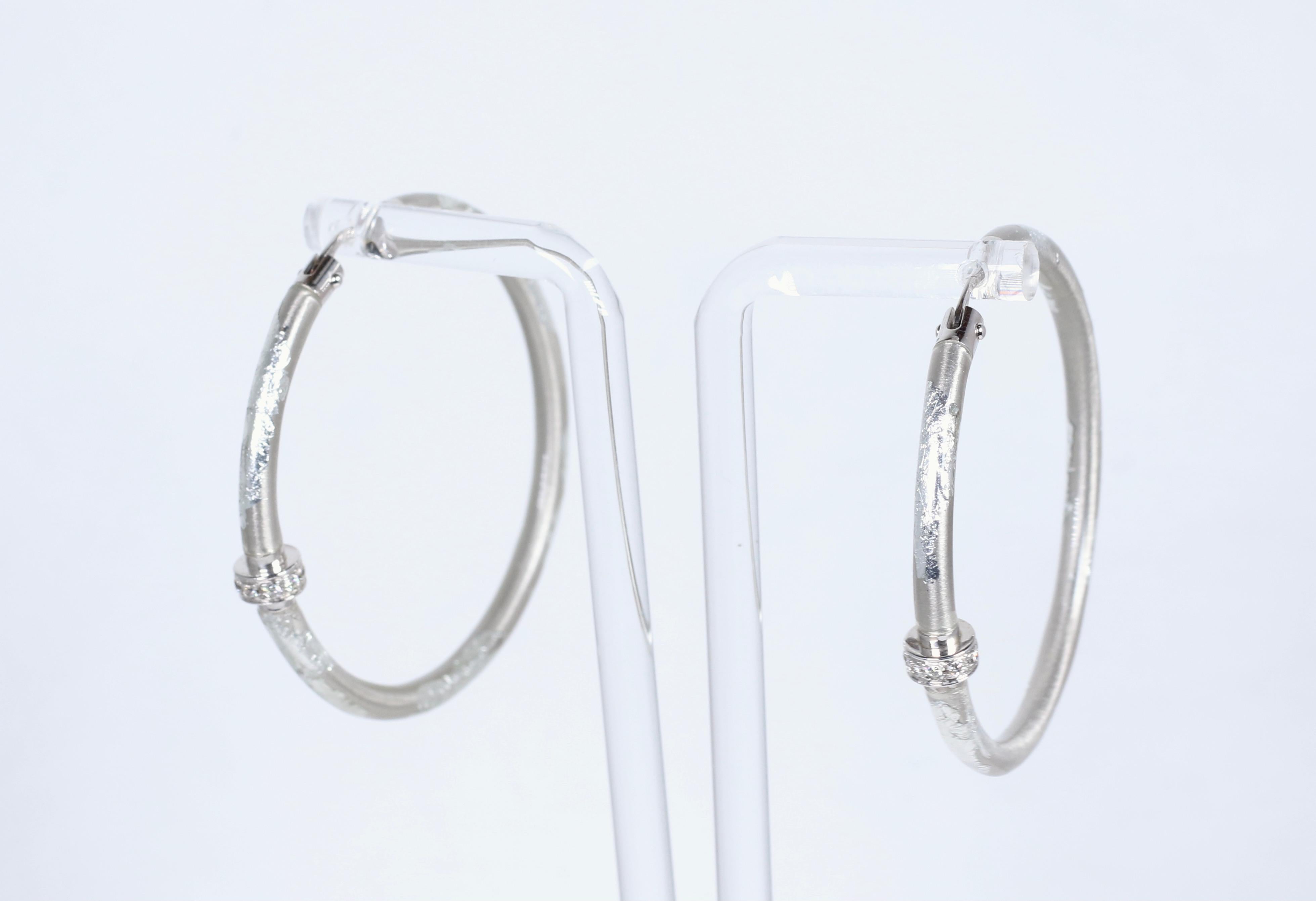 These Sterling Silver and Enamel hoops from SOHO come set with .14ctw of diamonds
