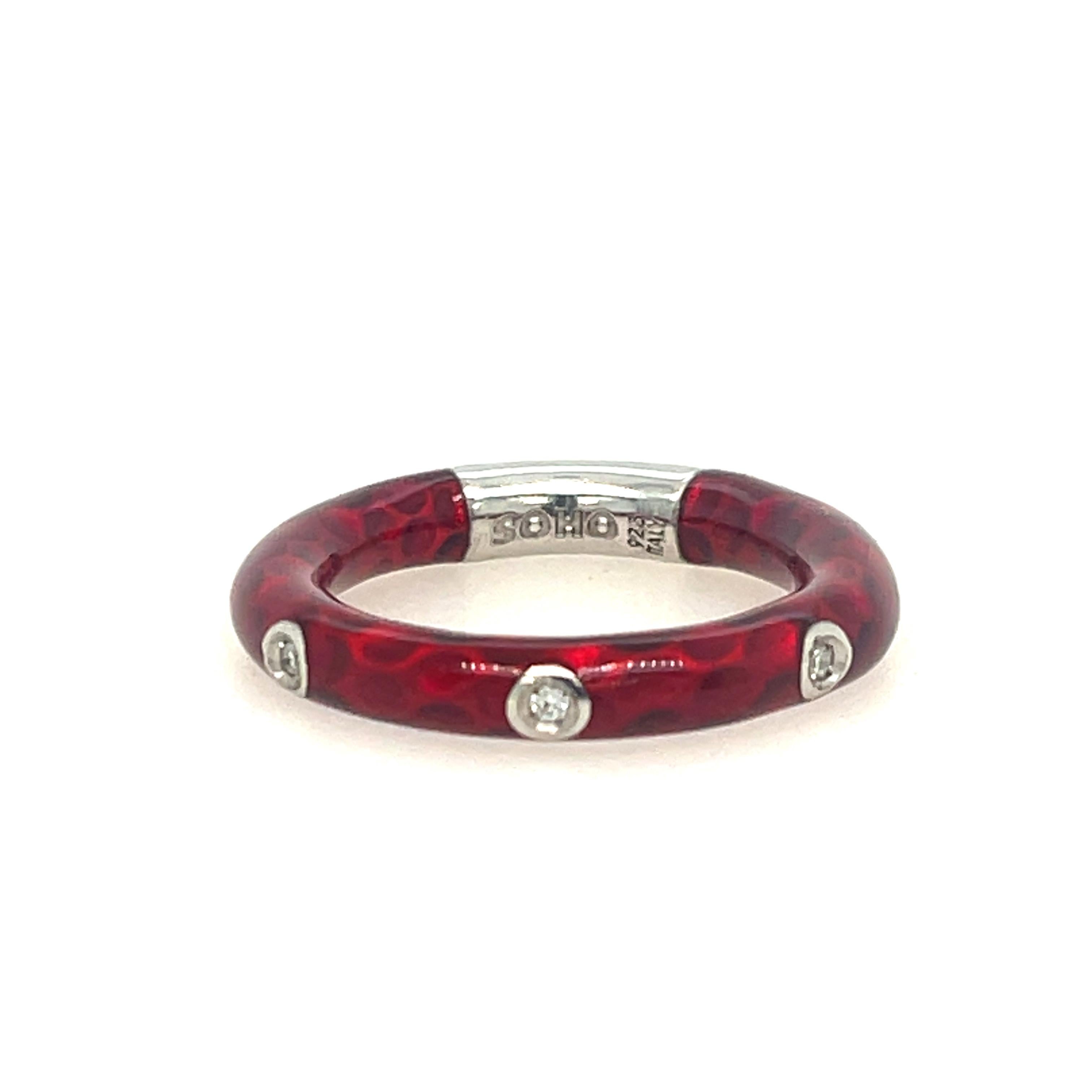 Sterling Silver and red enamel ring. Features three round diamond with 0.06ctw.

Ring size 7.25