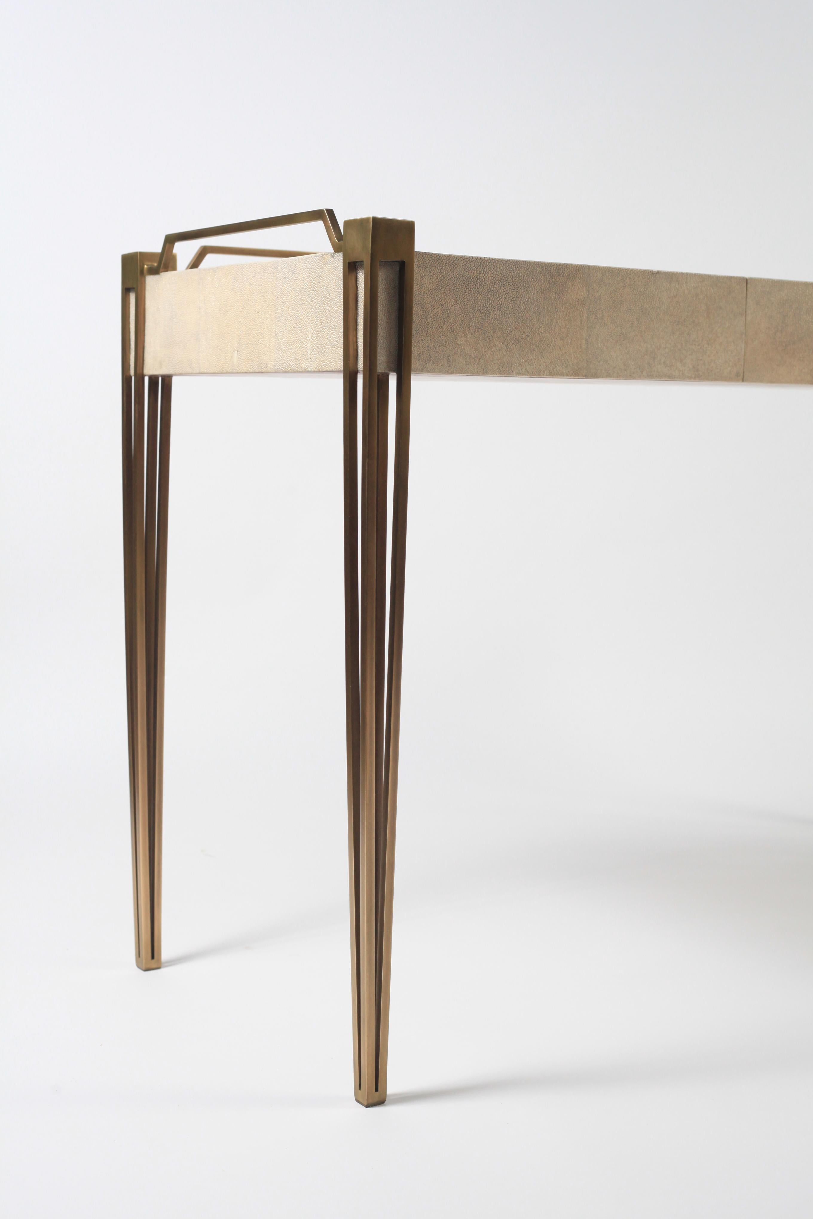 The Soho writing desk is the perfect piece for a living room, bedroom or office space that merges vintage and modern sensibility. Add a mirror and this desk becomes a vanity table. The surface of this desk is inlaid in cream shagreen, framed with