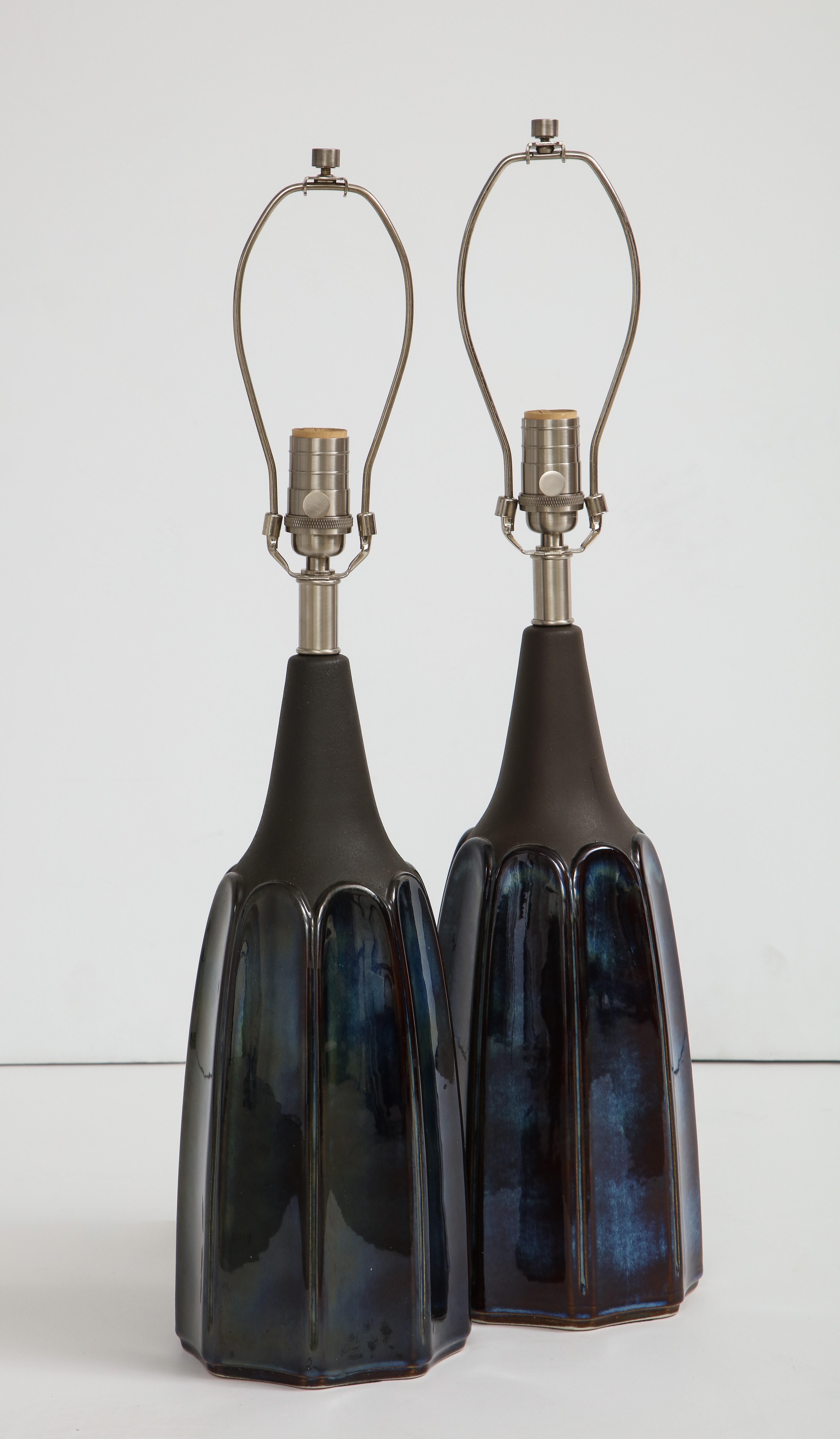 Pair of Scandinavian Modern porcelain lamps featuring a mottled blue body and matte gunmetal glazed necks and brushed nickel hardware. Rewired for use in the USA, 100W max bulbs.