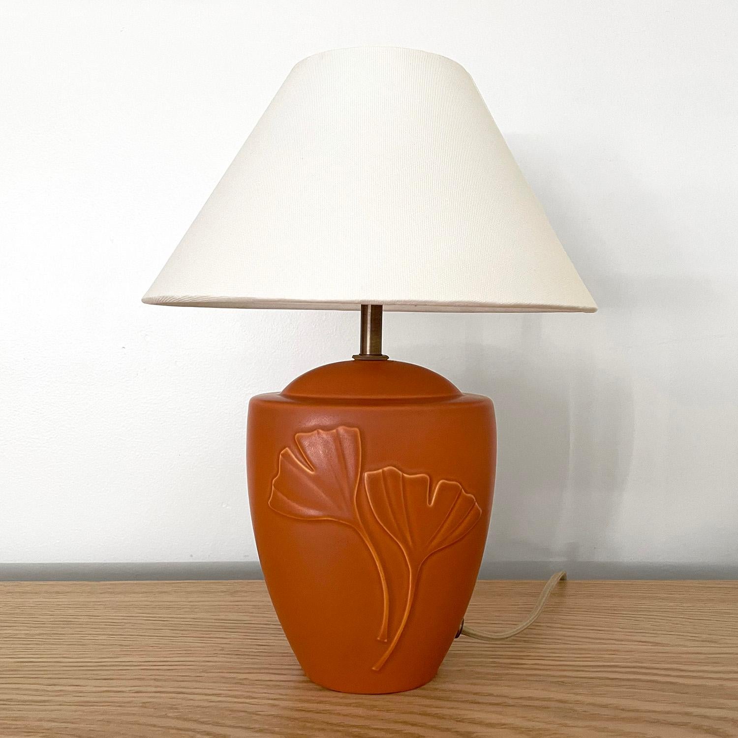 Soholm Danish stoneware gingko leaf lamp
Denmark, circa 1970s
Vibrant coral tone stoneware base
Two unique gingko leaf patterns which are a symbol of longevity
Newly rewired
New silk shade.