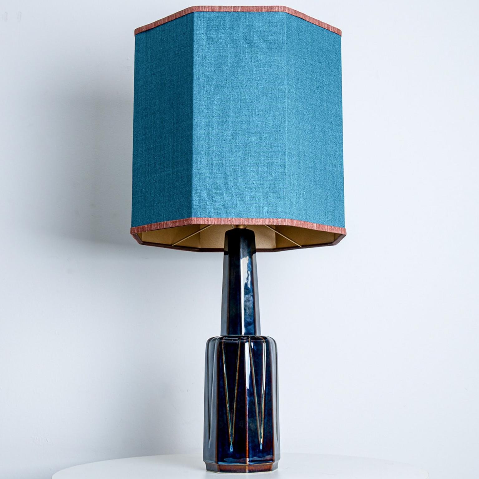 Ceramic table lamp by Soholm, Denmark, 1960s. This high-end sculptural piece is handmade ceramic in blue tones, with a combination of dry and glazed finishes. With a new custom made blue silk lamp shade with warm bronze inner-shade by René