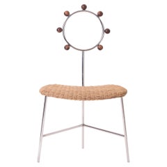 SOL minimalist chair handwoven in natural straw and stainless steel