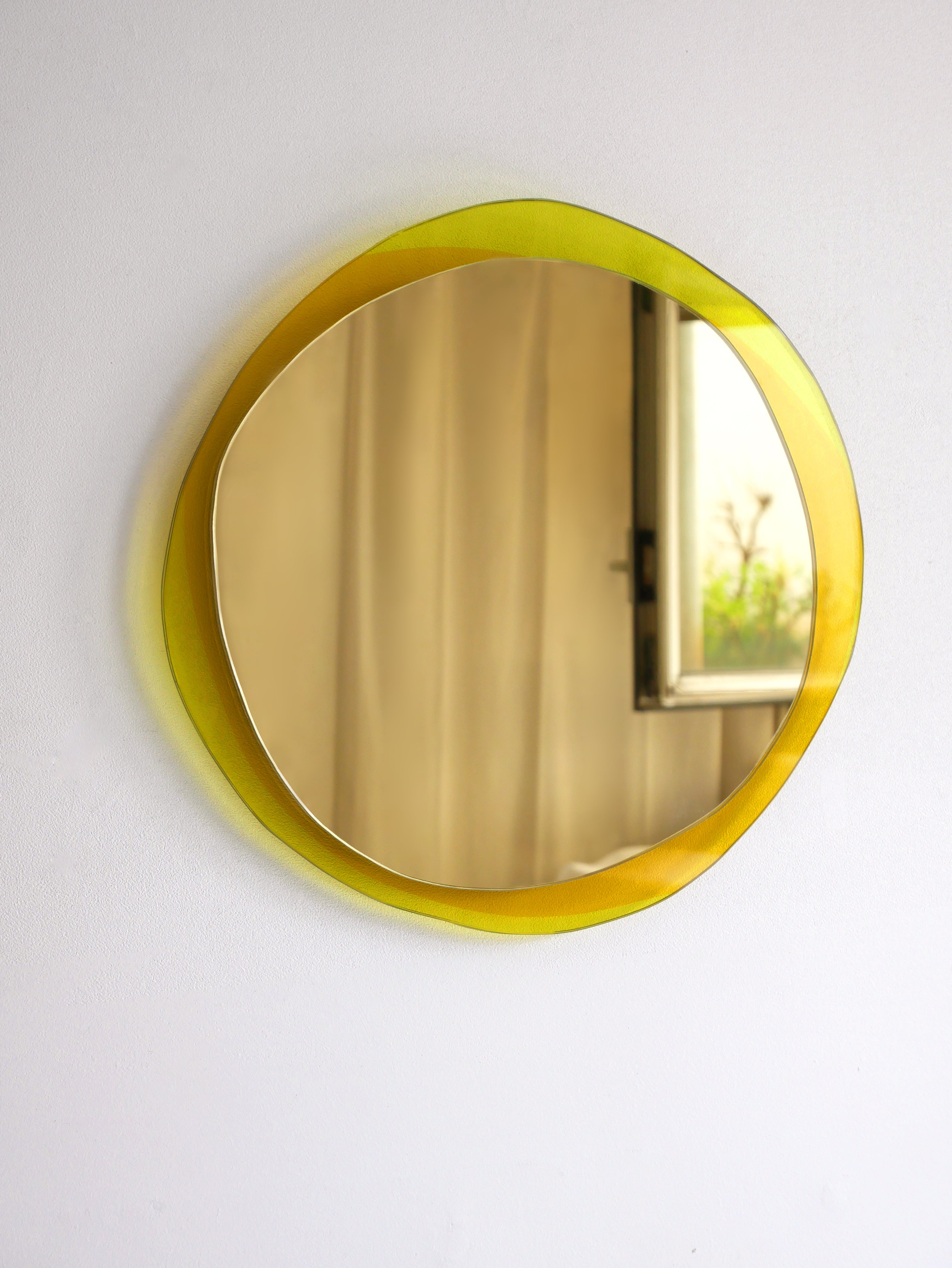 Solar large hand-sculpted mirror, Laurene Guarneri
Limited edition.
Handmade.
Materials: Gold colored mirror, gold and orange colored laminated glass.
Dimensions: 100 x 100 cm

Laurène Guarneri is a designer based in Paris.
Graduated in master's